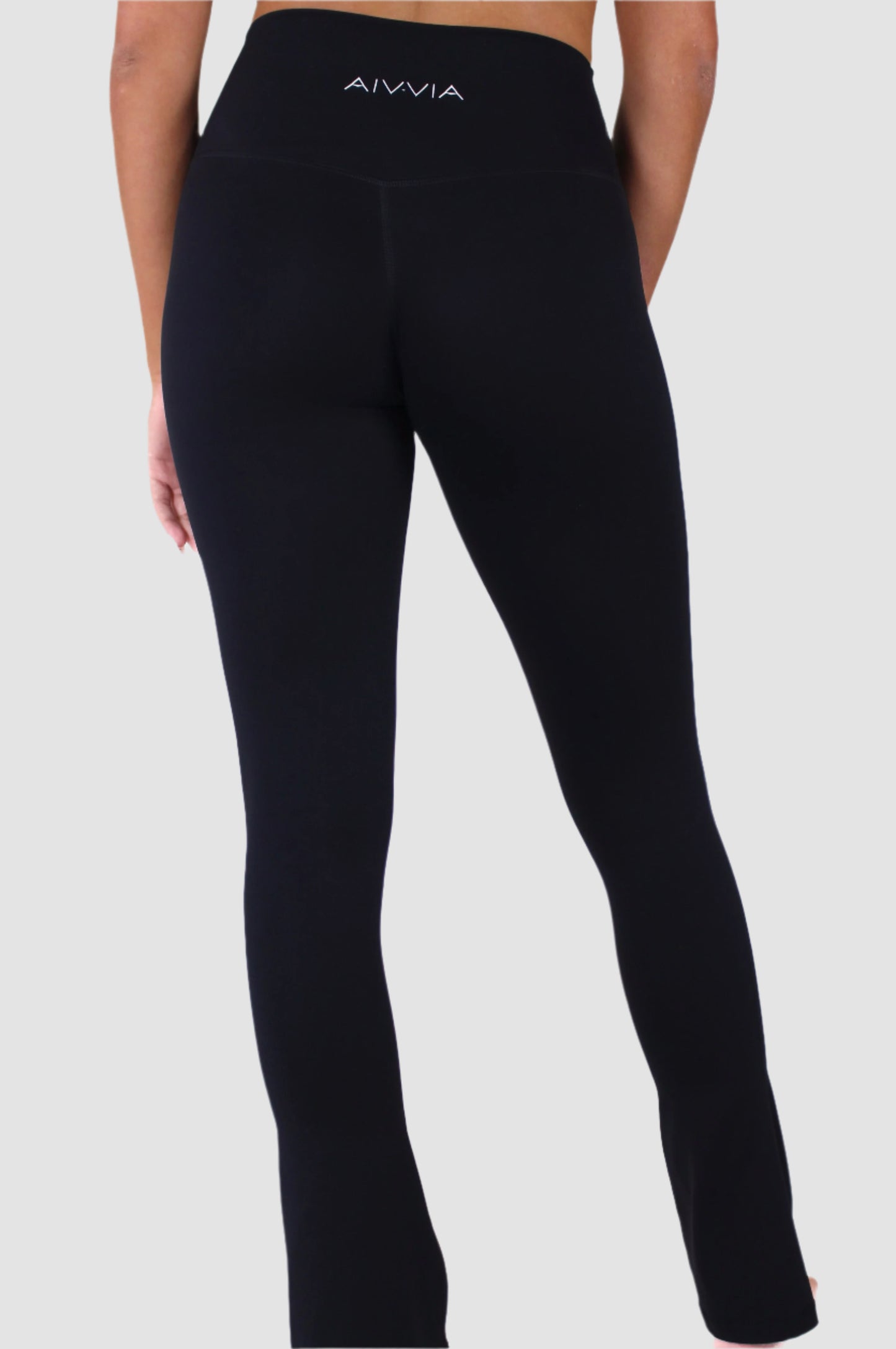 Angled back view of black Aivvia Athletics high-waisted flare pants showcasing sleek fit.