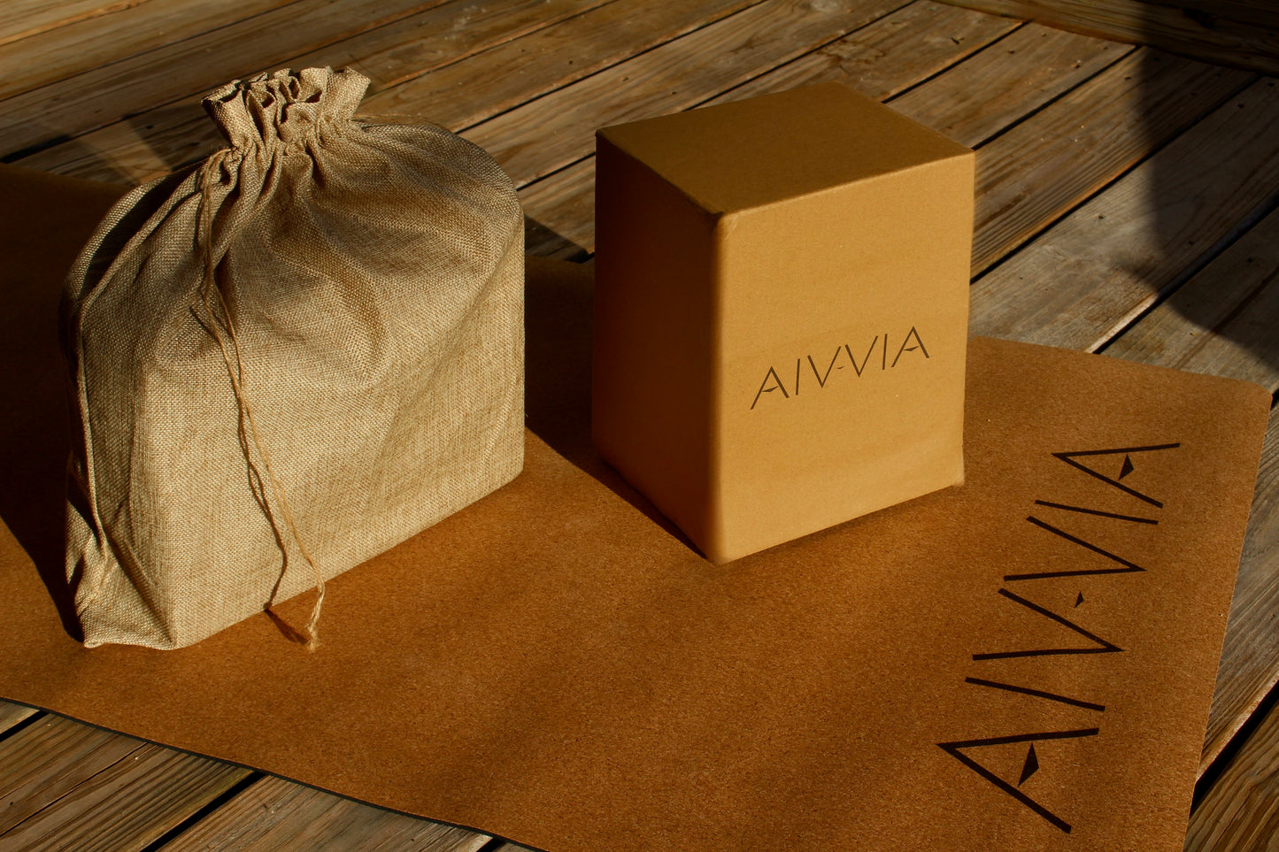 Cork yoga blocks and a drawstring bag displayed on a cork yoga mat.