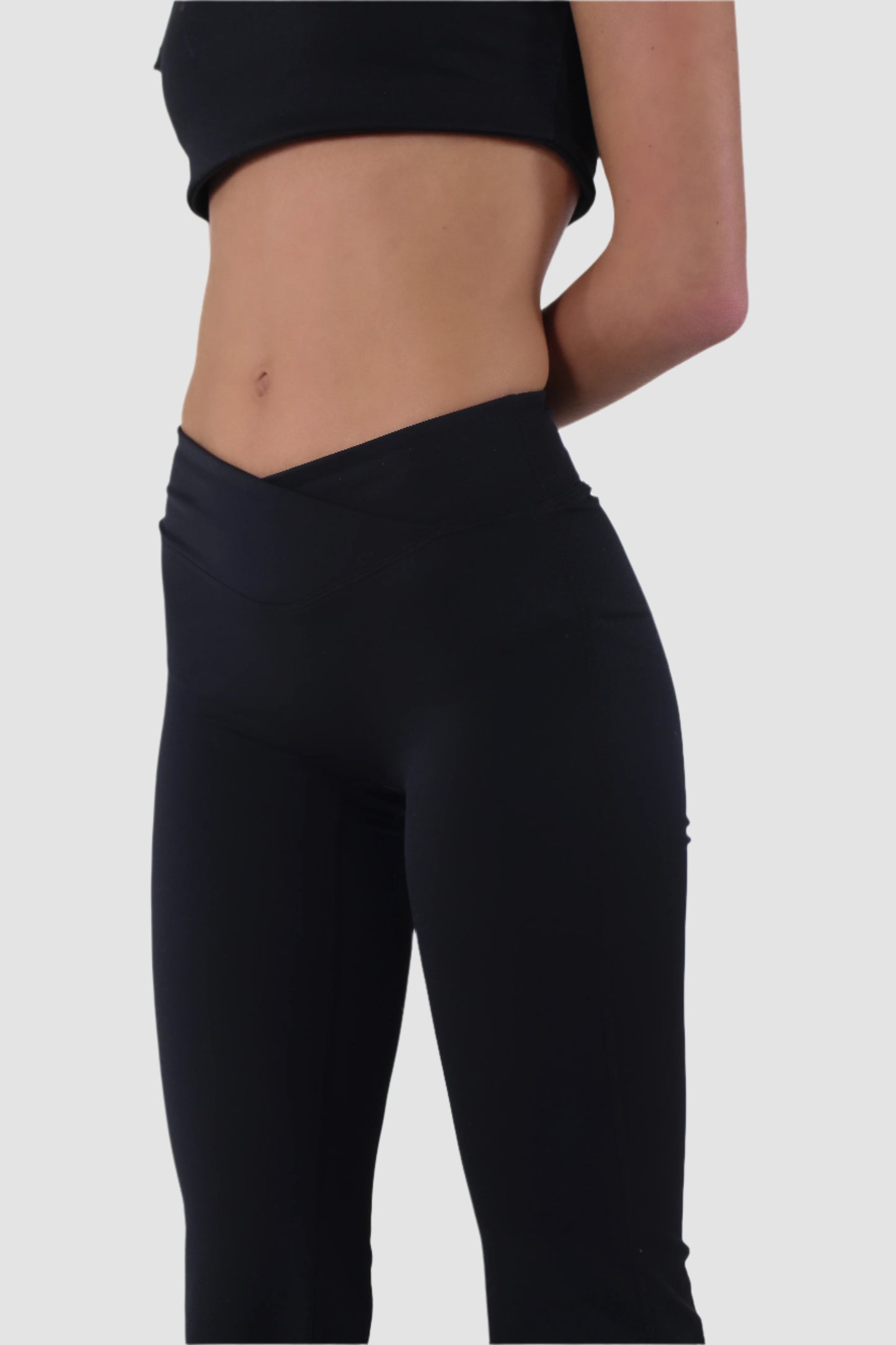 Side view of black Aivvia Athletics flare yoga pants, high-waist bootcut style for workouts and athleisure.