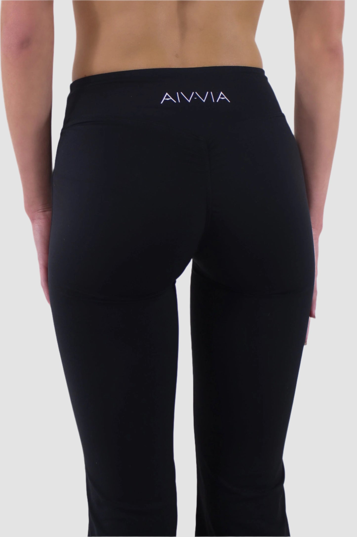 Back view of black Aivvia Athletics high-rise flare yoga pants, women’s bootcut activewear with seamless fit.