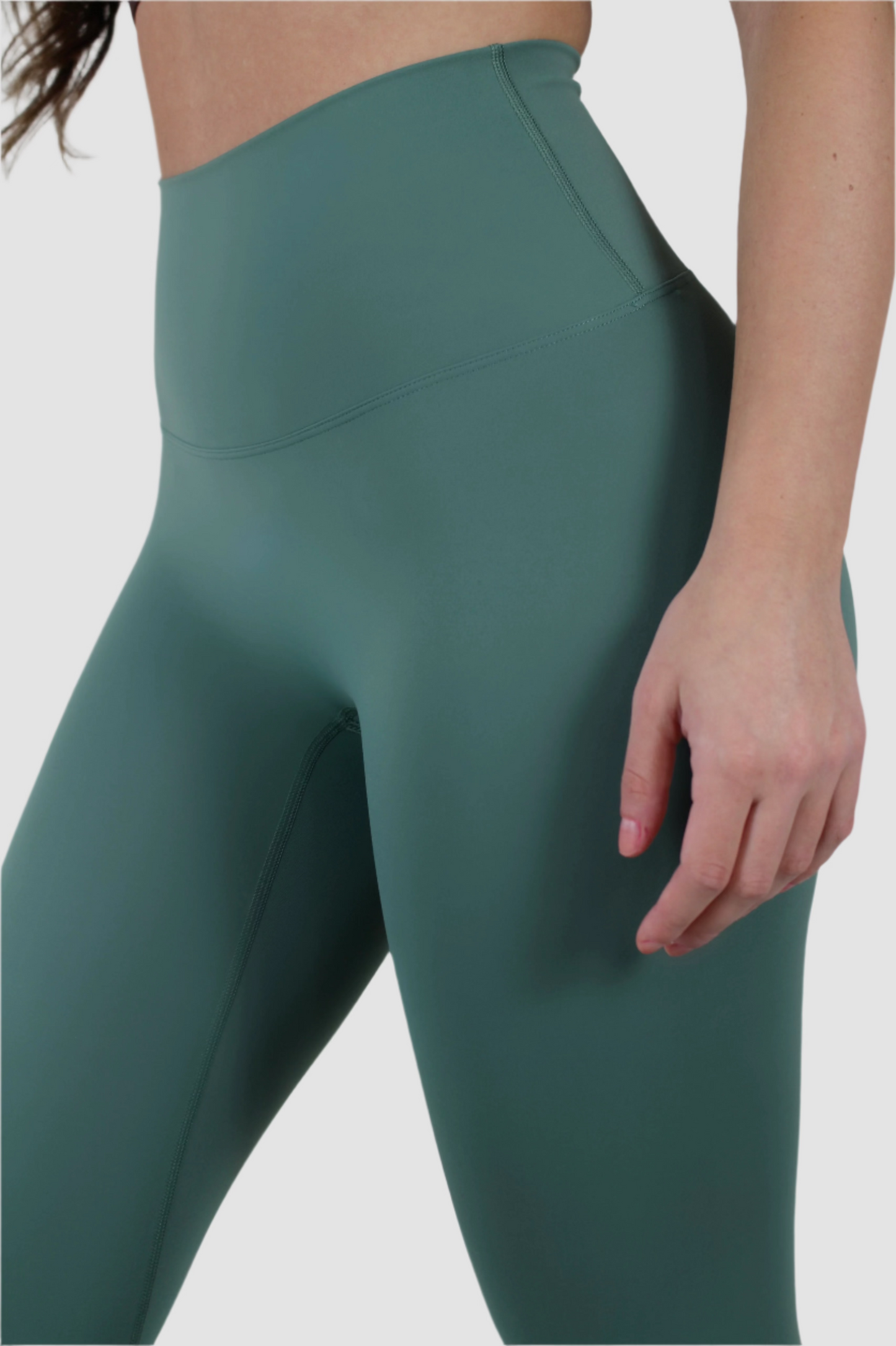 Side view of green Aivvia Athletics seamless leggings, women’s high-waist activewear tights with smooth fit.