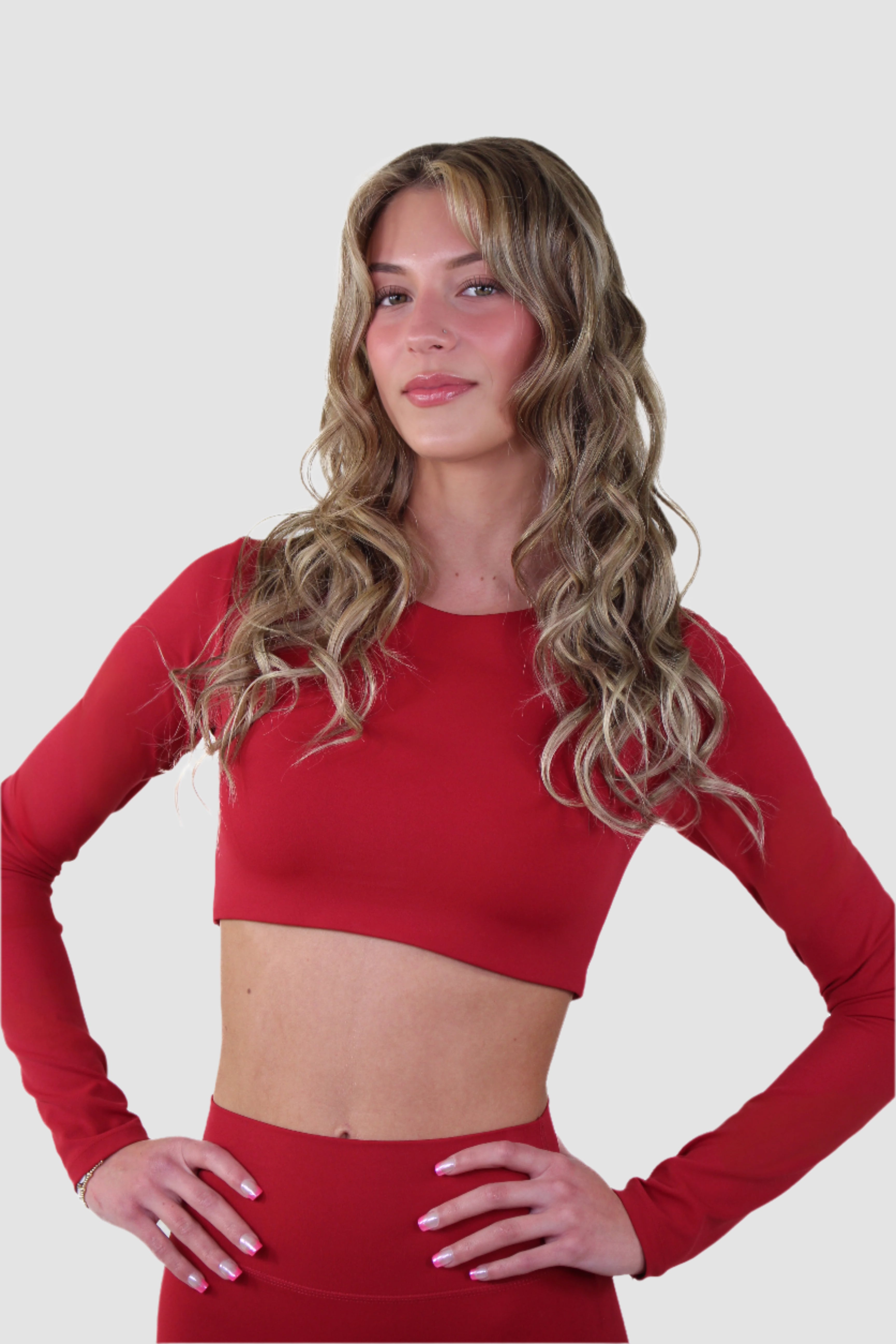 Aivvia Athletics red long sleeve sports bra with sleek, compressive fit for training and athleisure wear.