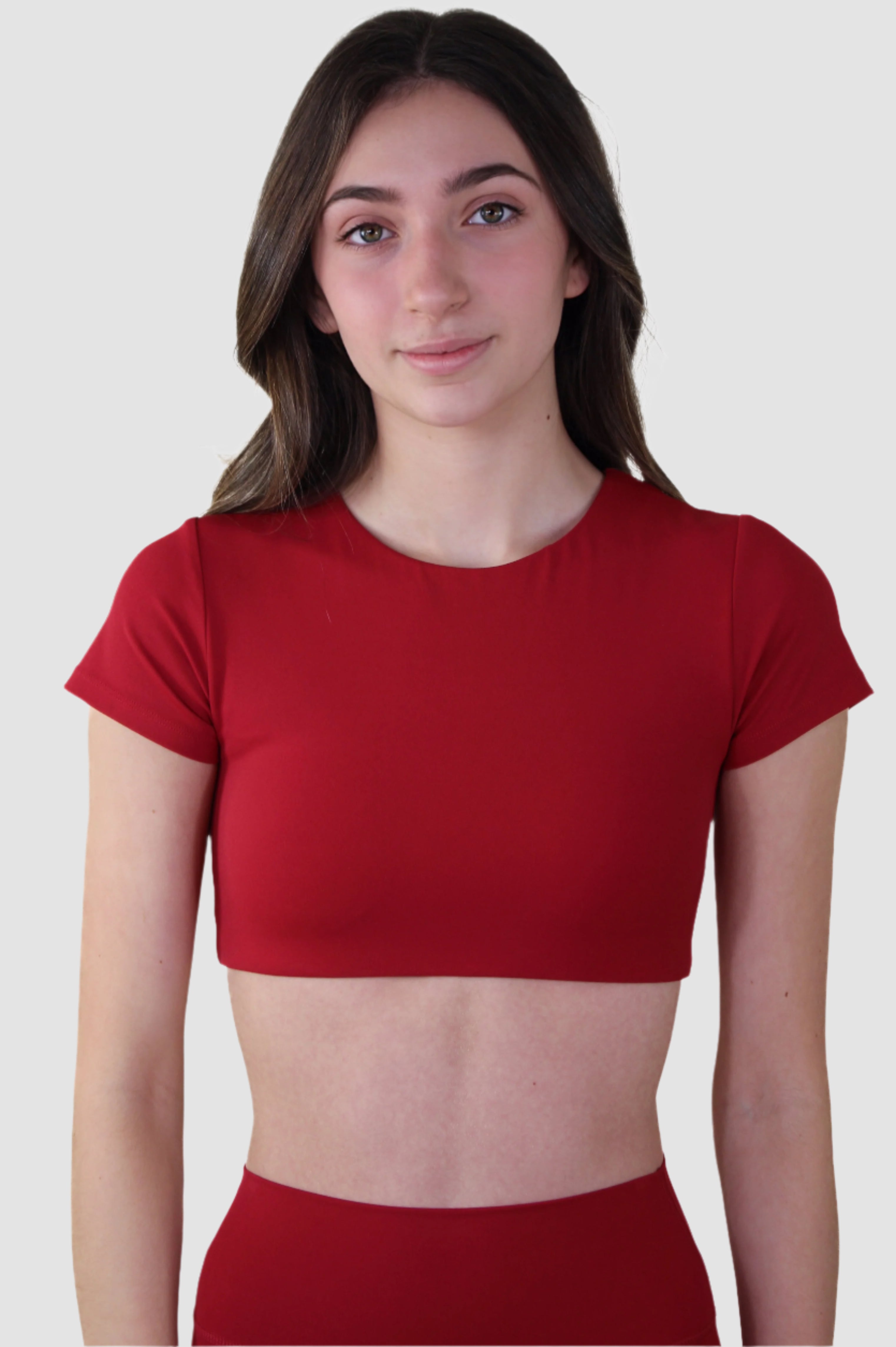 Front view of red Aivvia Athletics t-shirt bra, cropped and form-fitting for active performance.