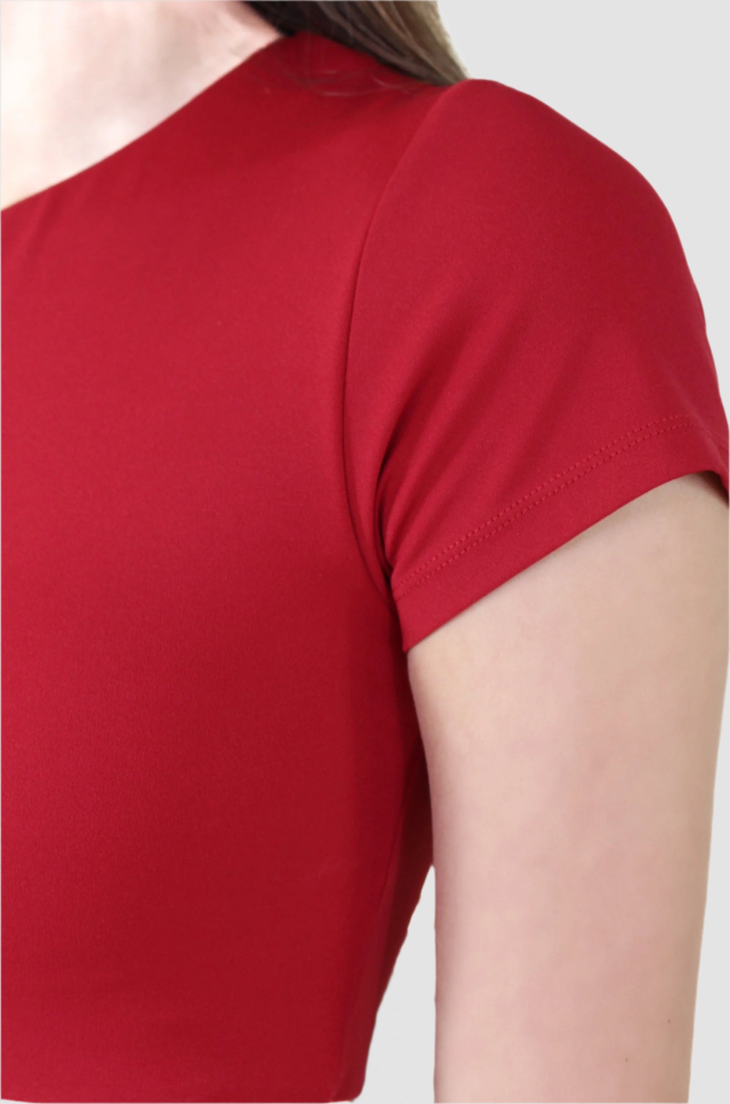 Close-up of red Aivvia athletic crop top sleeve, showcasing stretch fabric and clean seams.