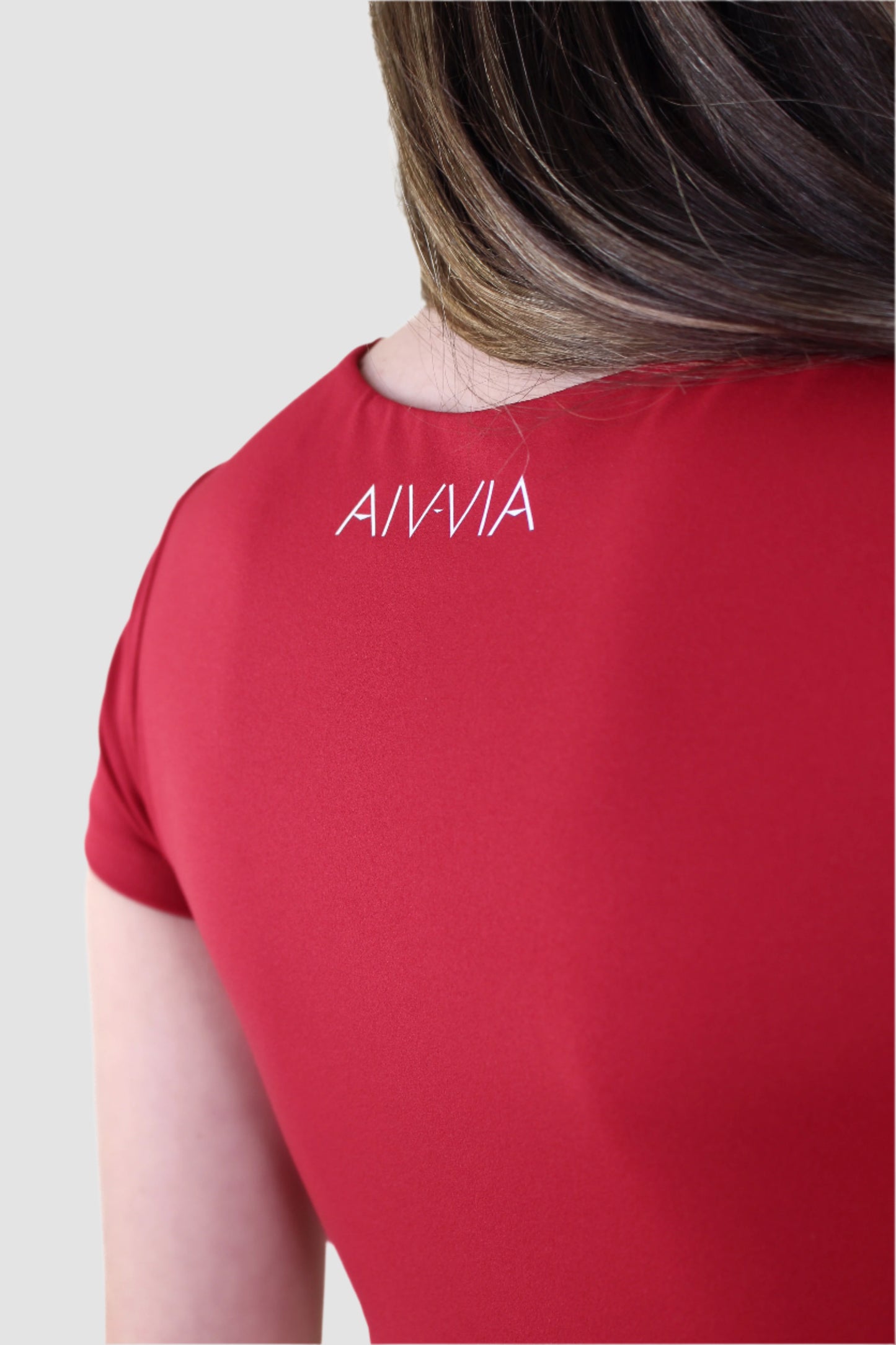 Back view of red Aivvia t-shirt bra with logo detail, designed for style and function.