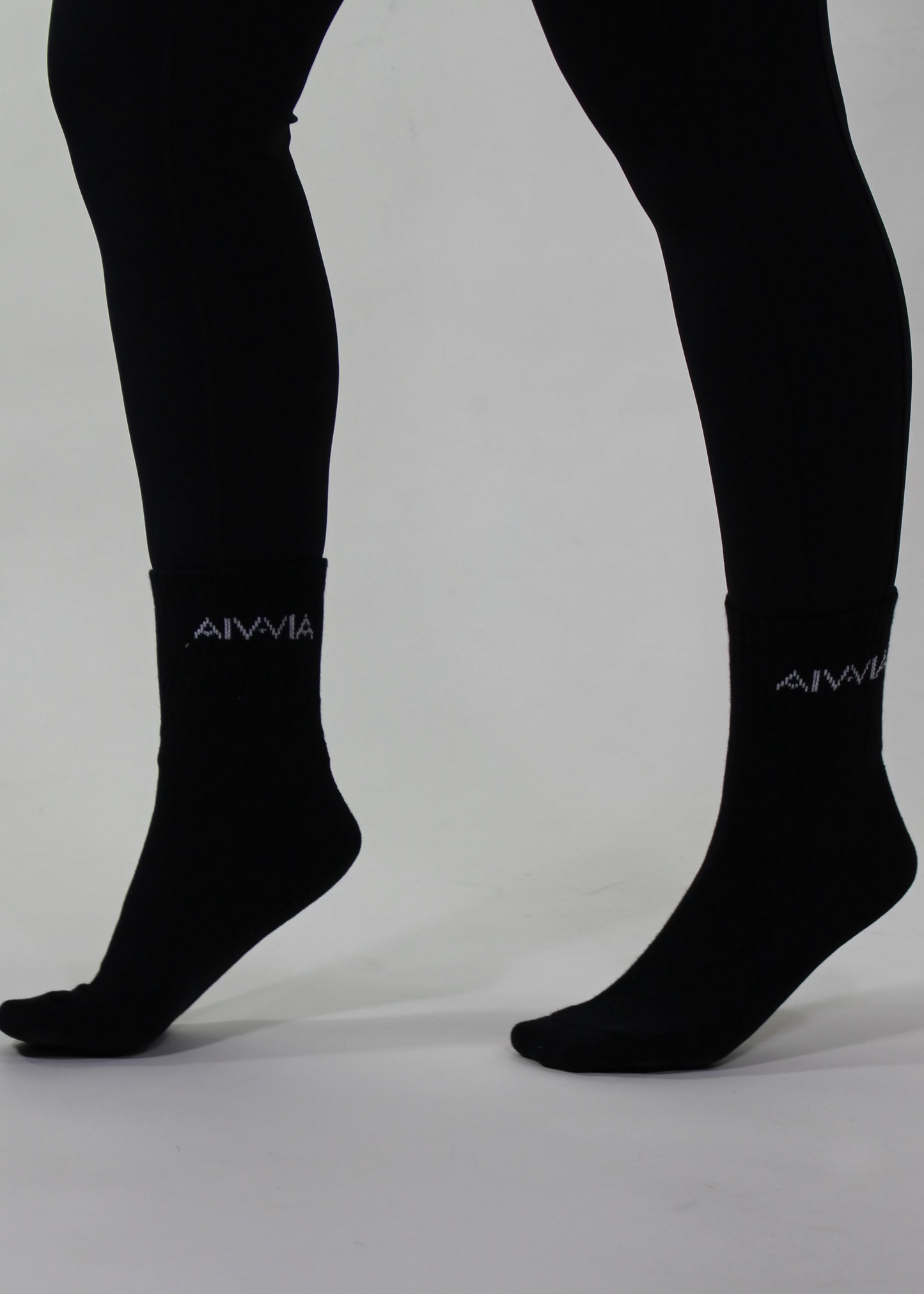 Black socks with a brand logo on a gray background