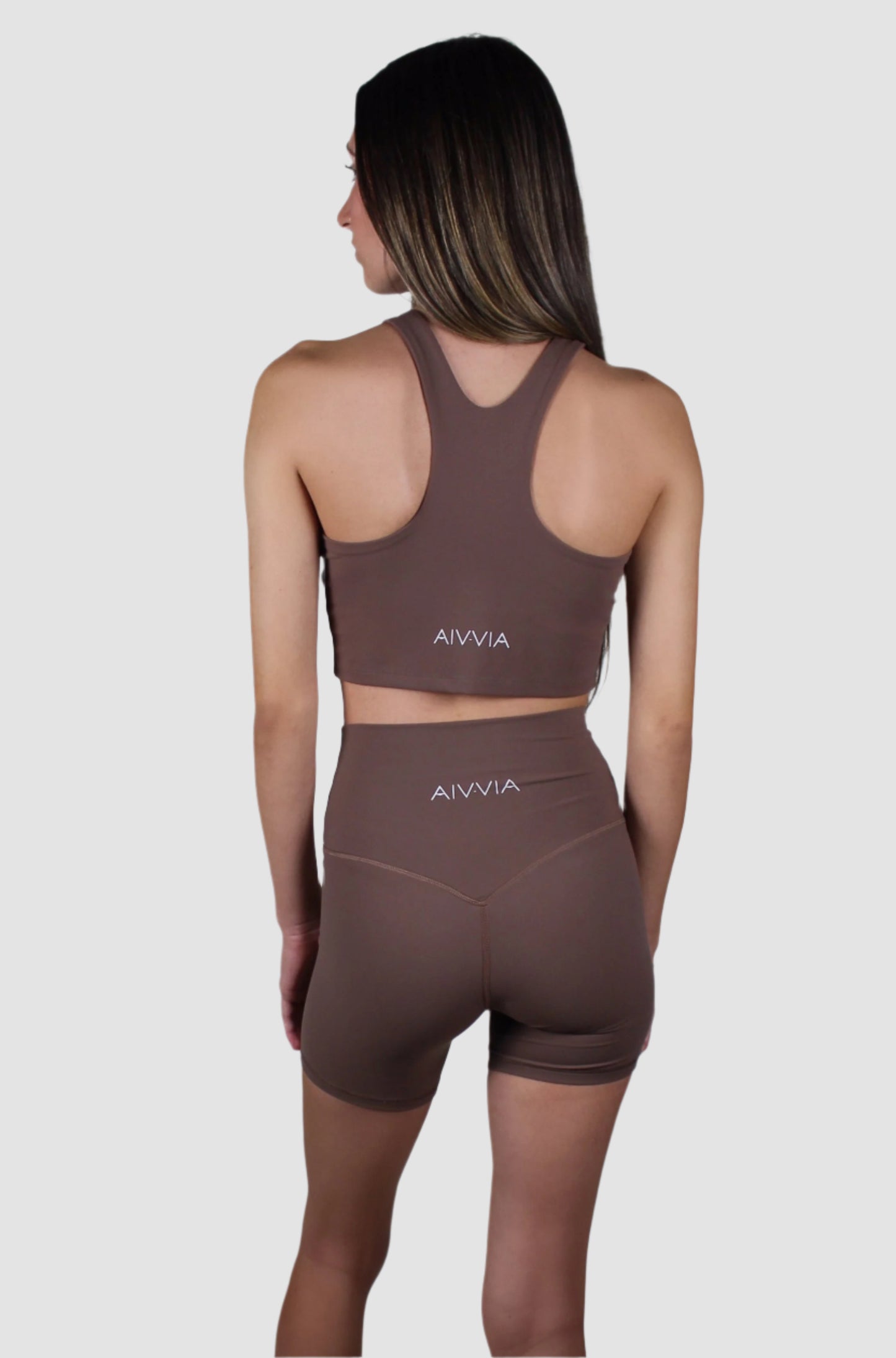Back view of the chocolate brown activewear set with a racerback top and fitted high-waisted biker shorts.