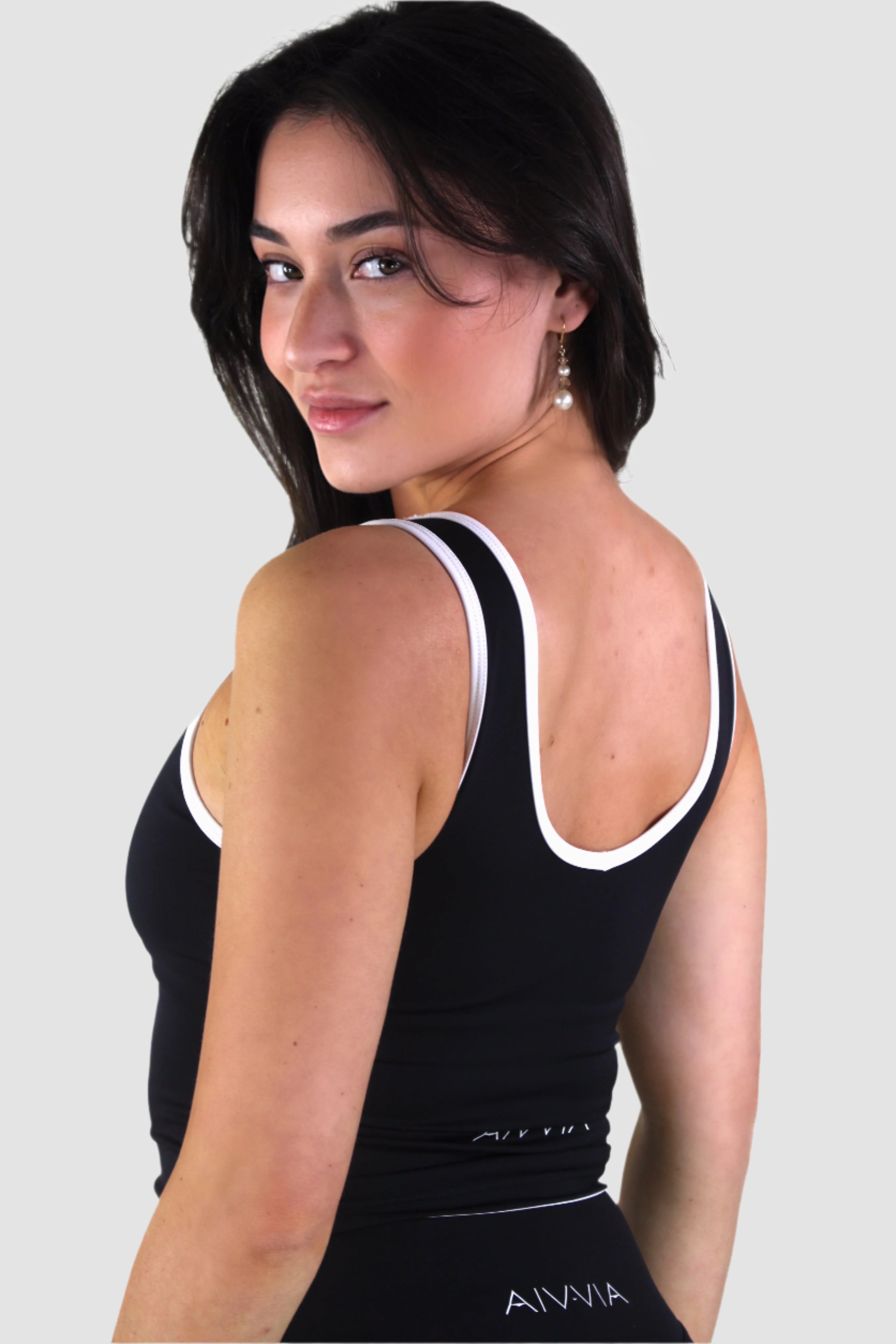 Side-back view of black Aivvia Athletics athletic tank top, racerback design for active movement.