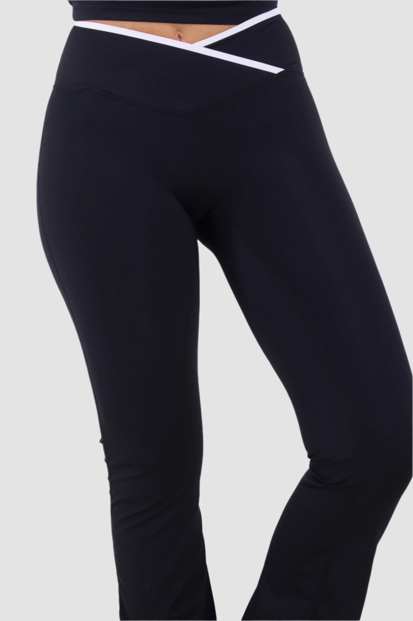 Side view of black Aivvia Athletics yoga pants with crossover waistband, sleek activewear design.