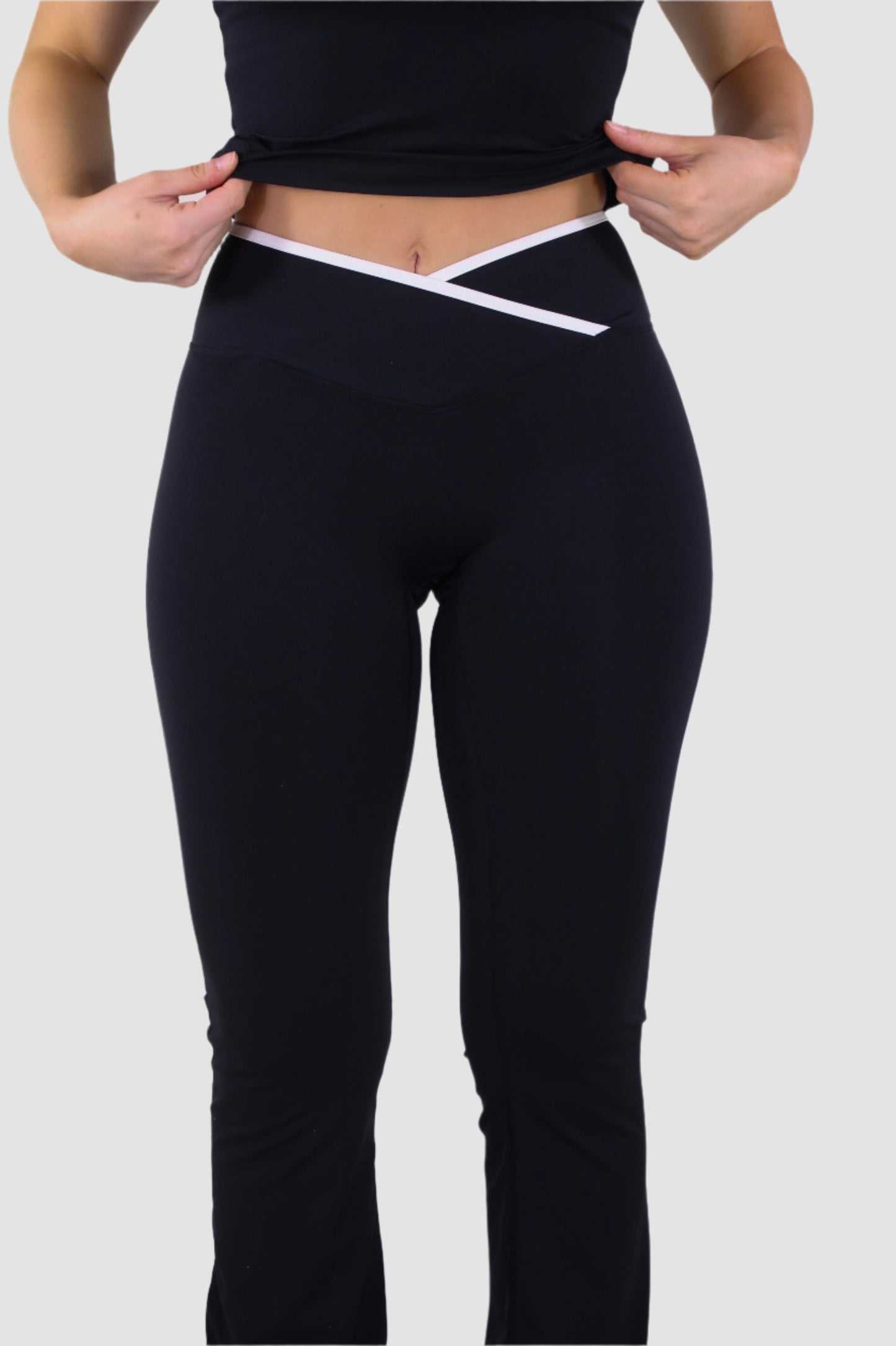 Front view of black Aivvia Athletics yoga pants, high-rise crossover waistband for flattering fit.