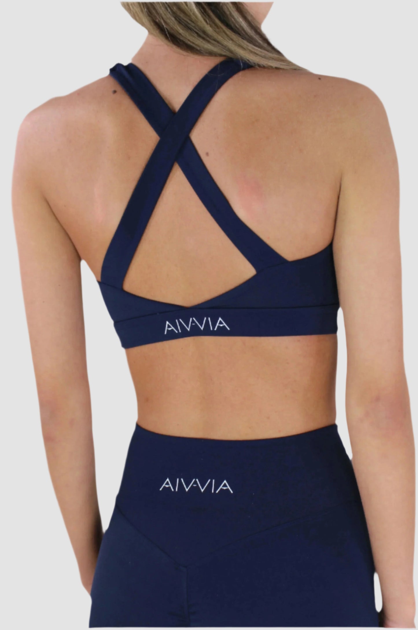 Back view of Aivvia Athletics navy sports bra with crisscross straps and open back for ventilation and style.