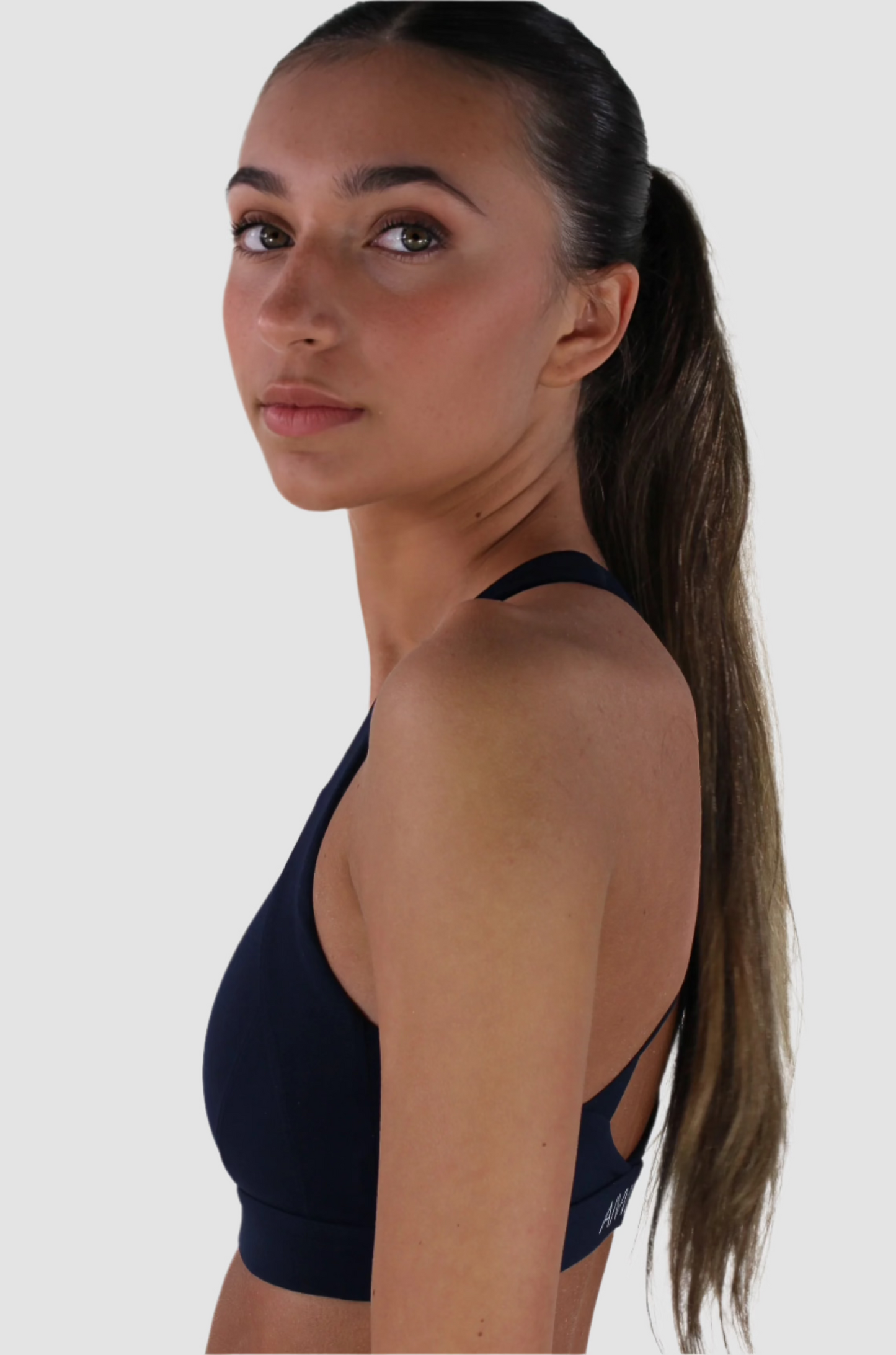 Side profile of Aivvia Athletics navy sports bra with supportive racerback and body-hugging compression fit.