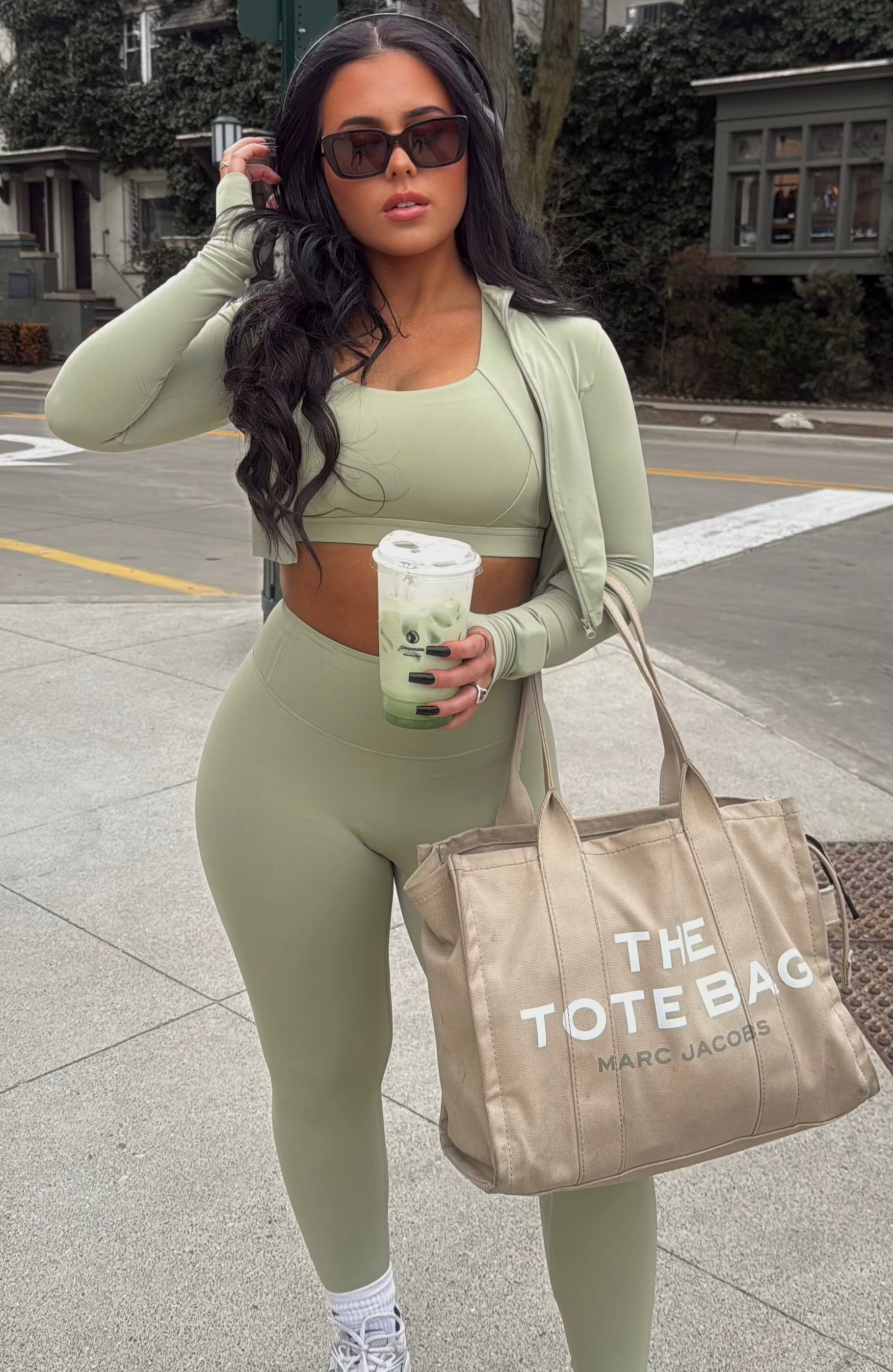 Sage green Aivvia Athletics cropped zip-up jacket styled for everyday wear with leggings.