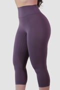 Purple capri leggings worn by a person on a white background