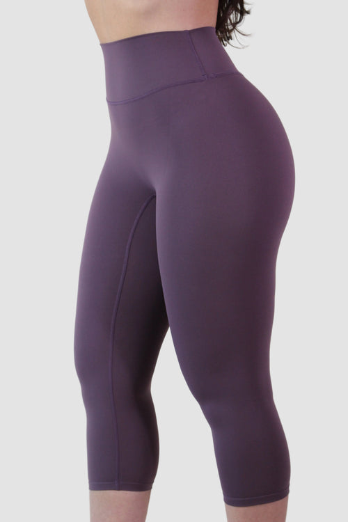 Purple capri leggings worn by a person on a white background