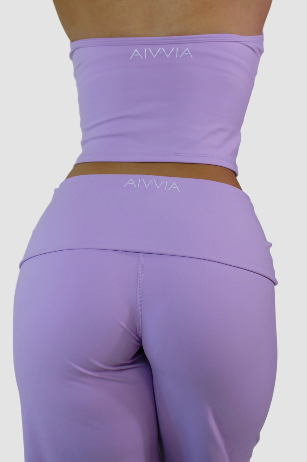 Purple athletic outfit with 'AIVVIA' branding on a plain background