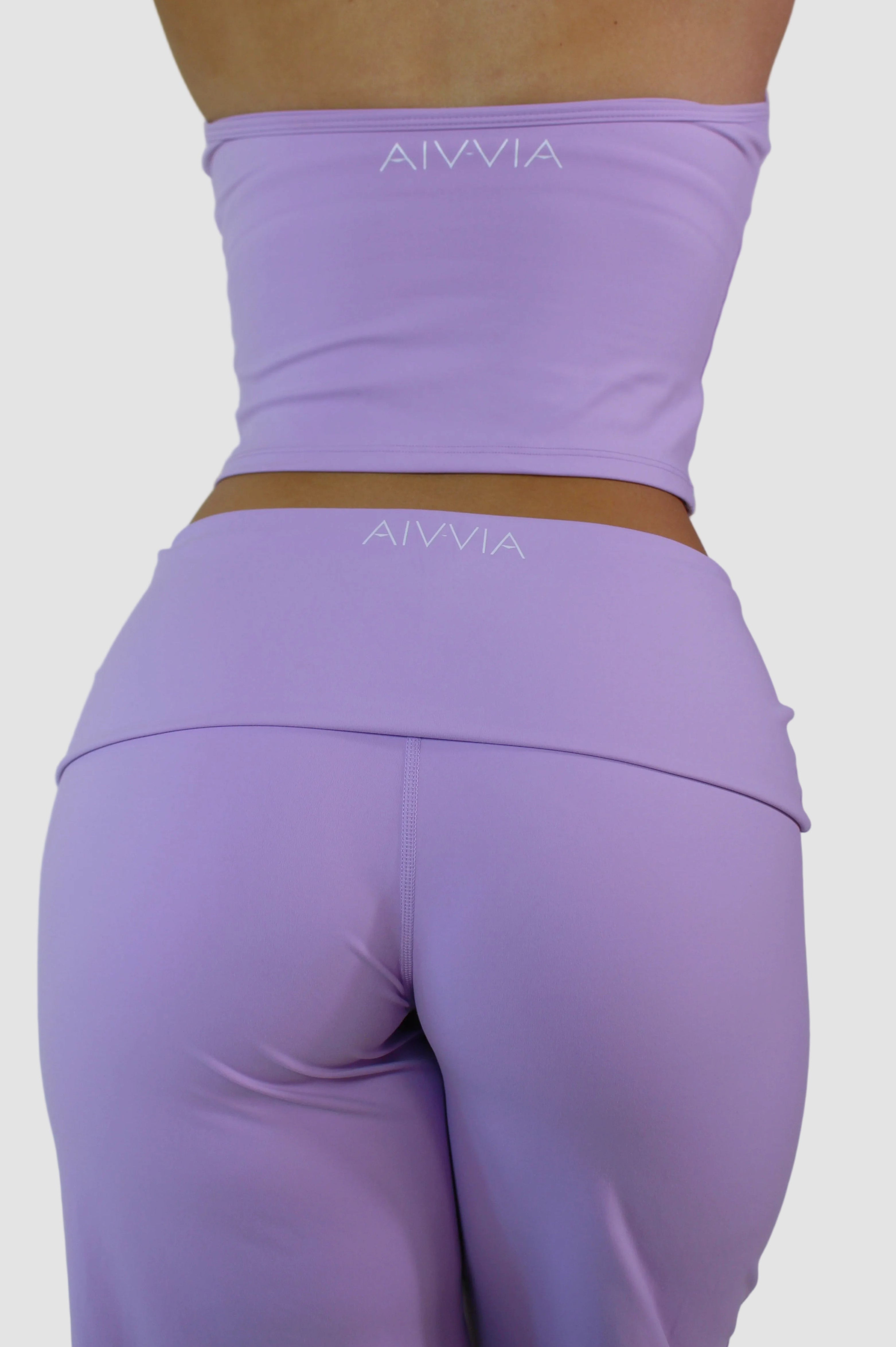 Purple athletic outfit with 'AIVVIA' branding on a plain background