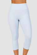 Light blue high-waisted capri leggings shown on a model from the waist down against a plain off-white studio background.