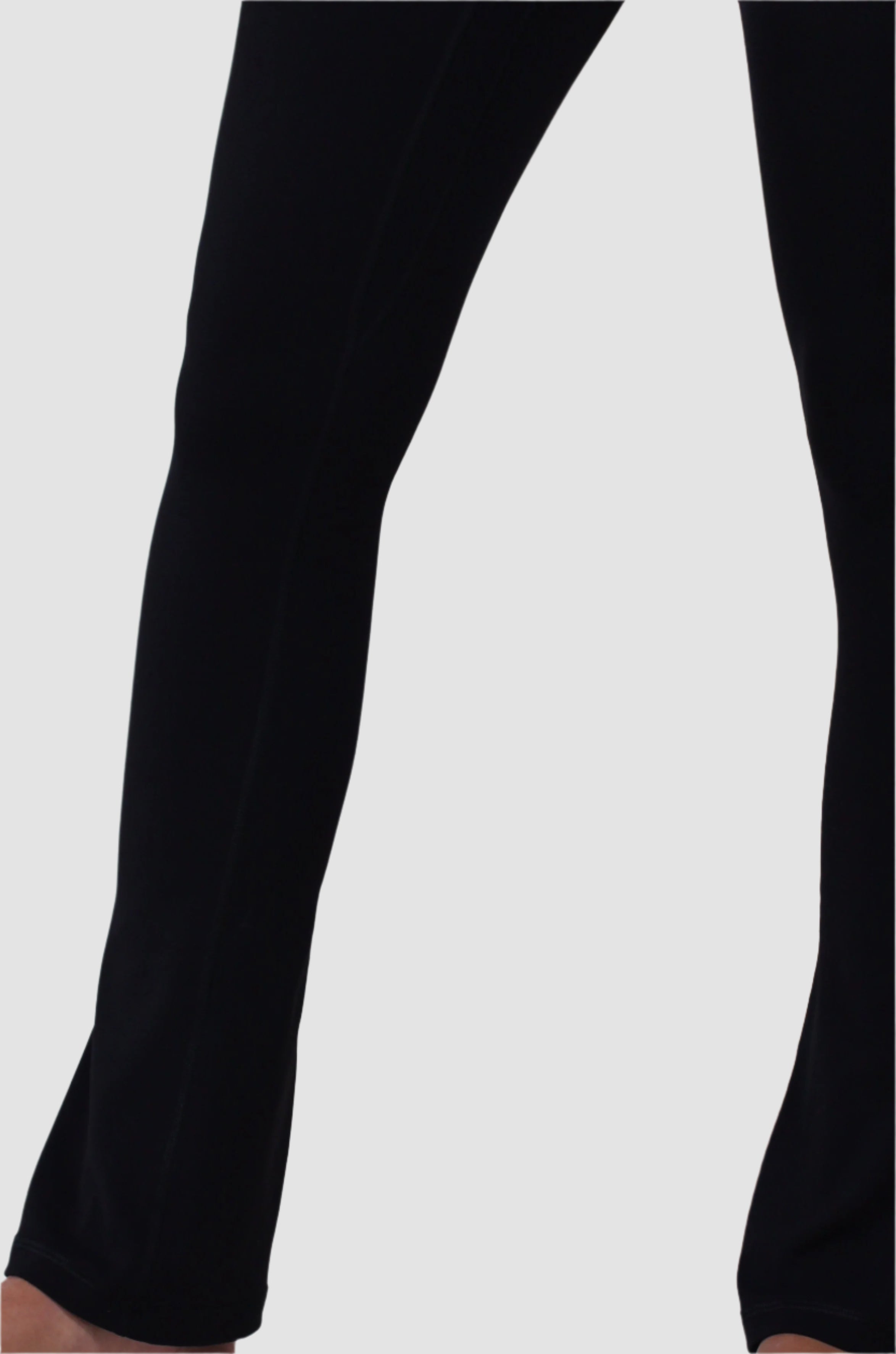 Close-up side view of black Aivvia Athletics flare pants hem showing flared leg opening.

