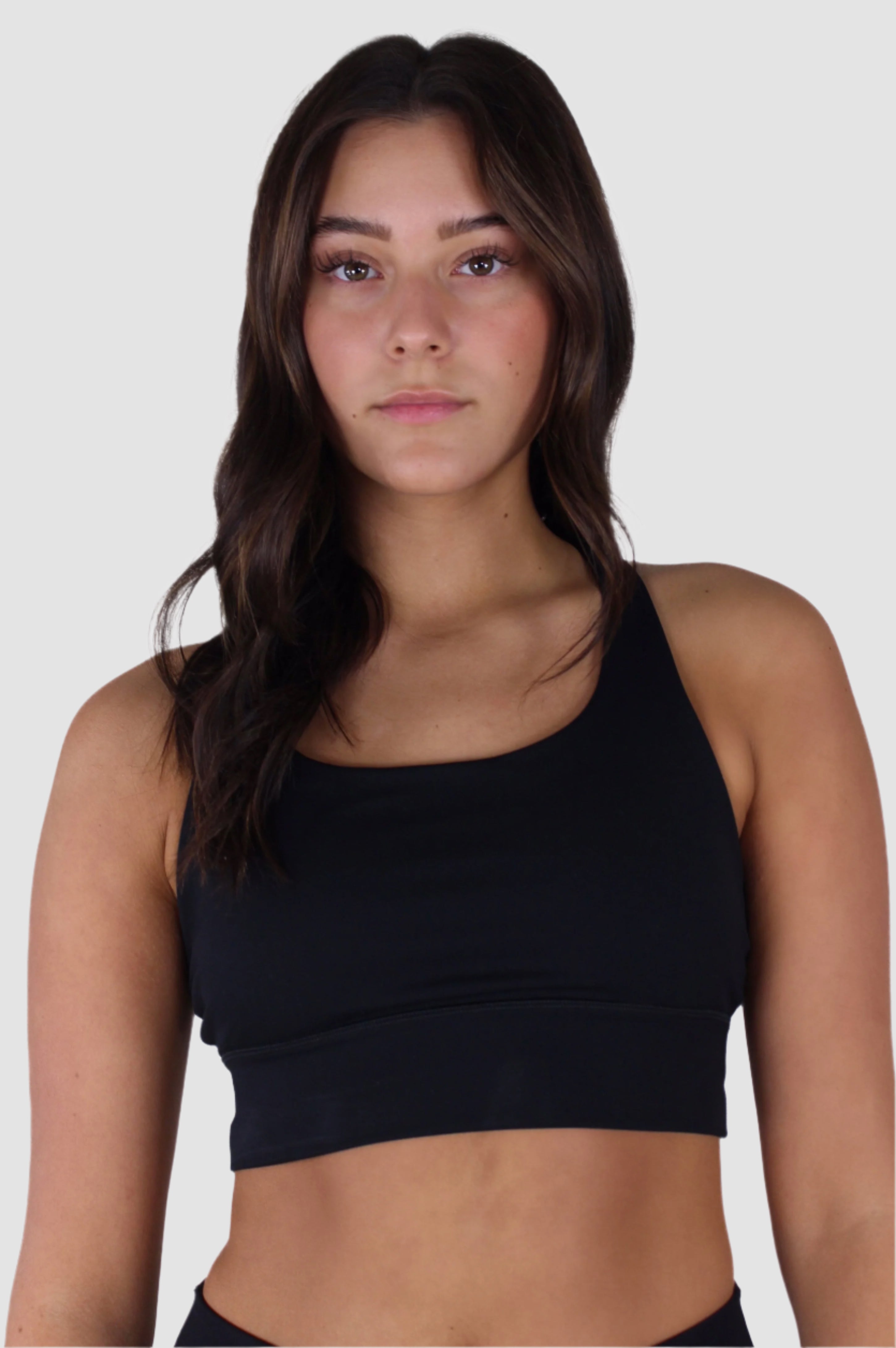 Front view of black Aivvia Athletics sports bra with scoop neckline and wide straps.