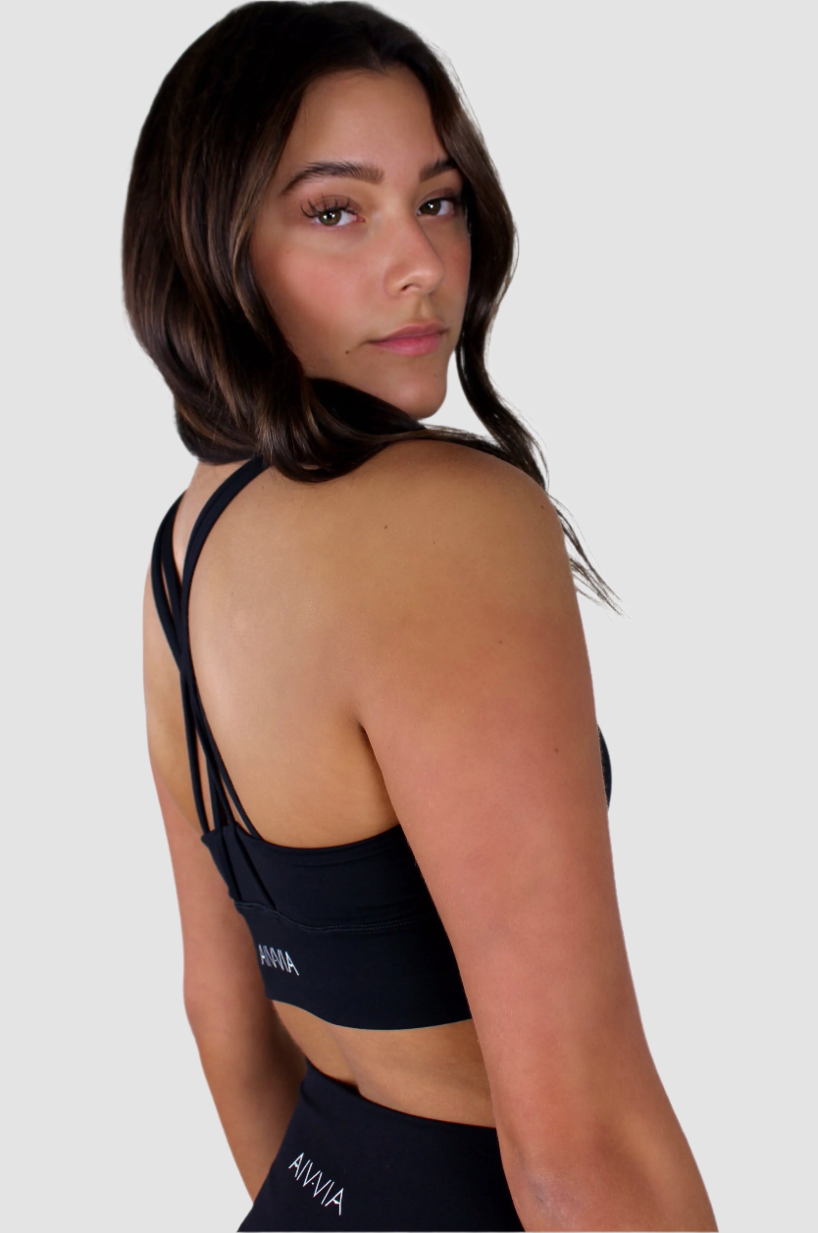 Back view of black Aivvia Athletics sports bra showing crisscross strap design.