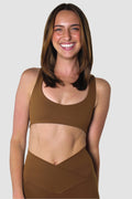Front view of a mocha brown activewear set featuring a scoop-neck sports bra and high-waisted V-cut biker shorts.