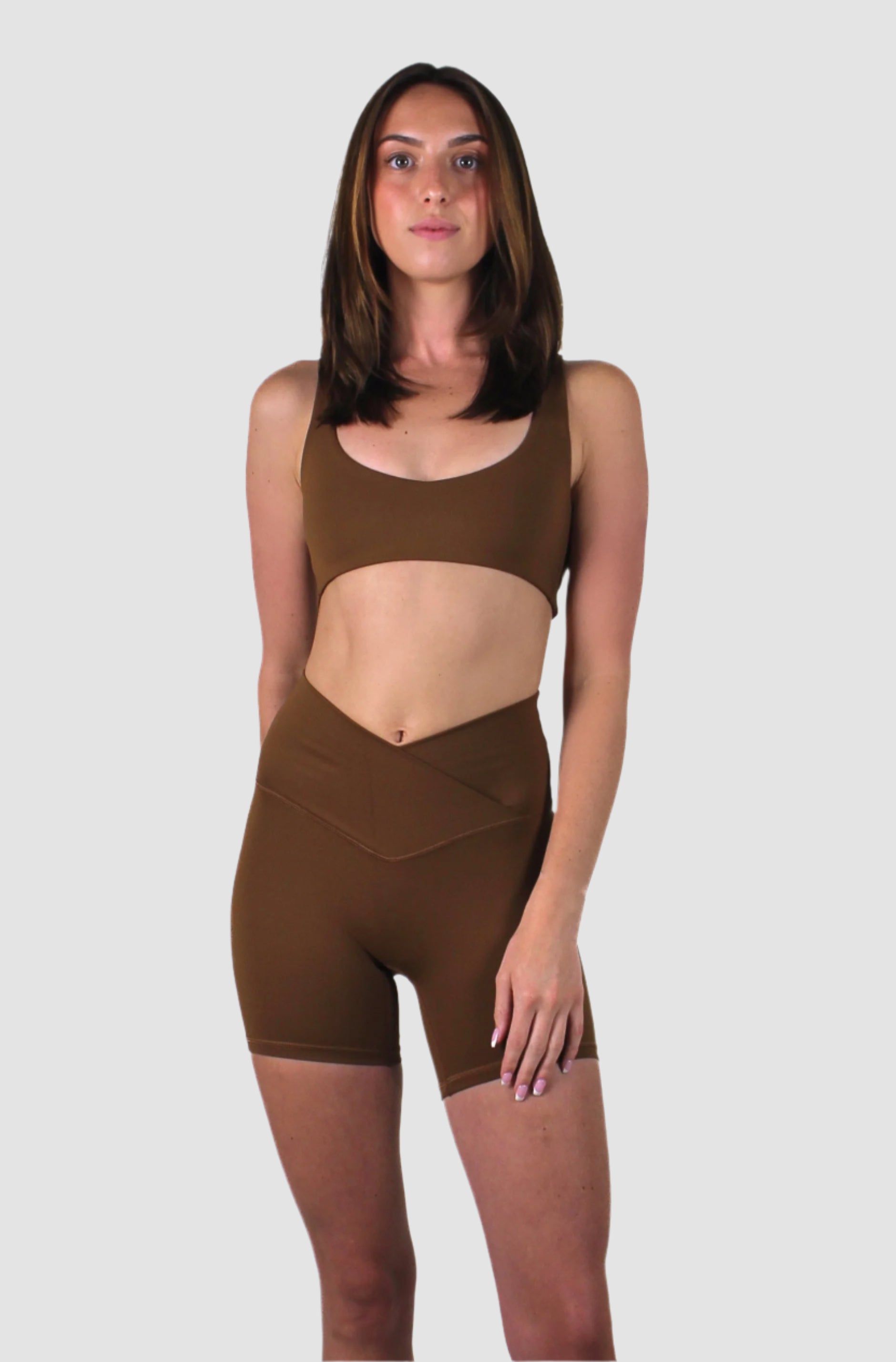 Full front view of the mocha brown activewear set with scoop-neck sports bra and form-fitting V-cut shorts.