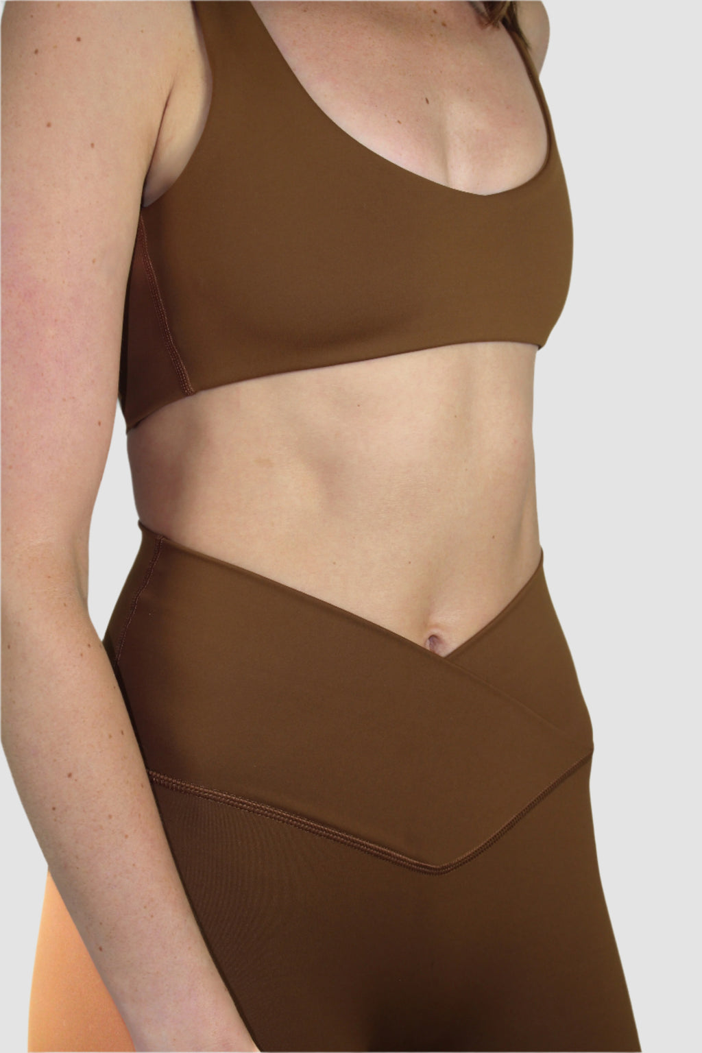 Close-up of the mocha brown activewear set, focusing on the textured V-cut waistband and fitted design of the shorts.