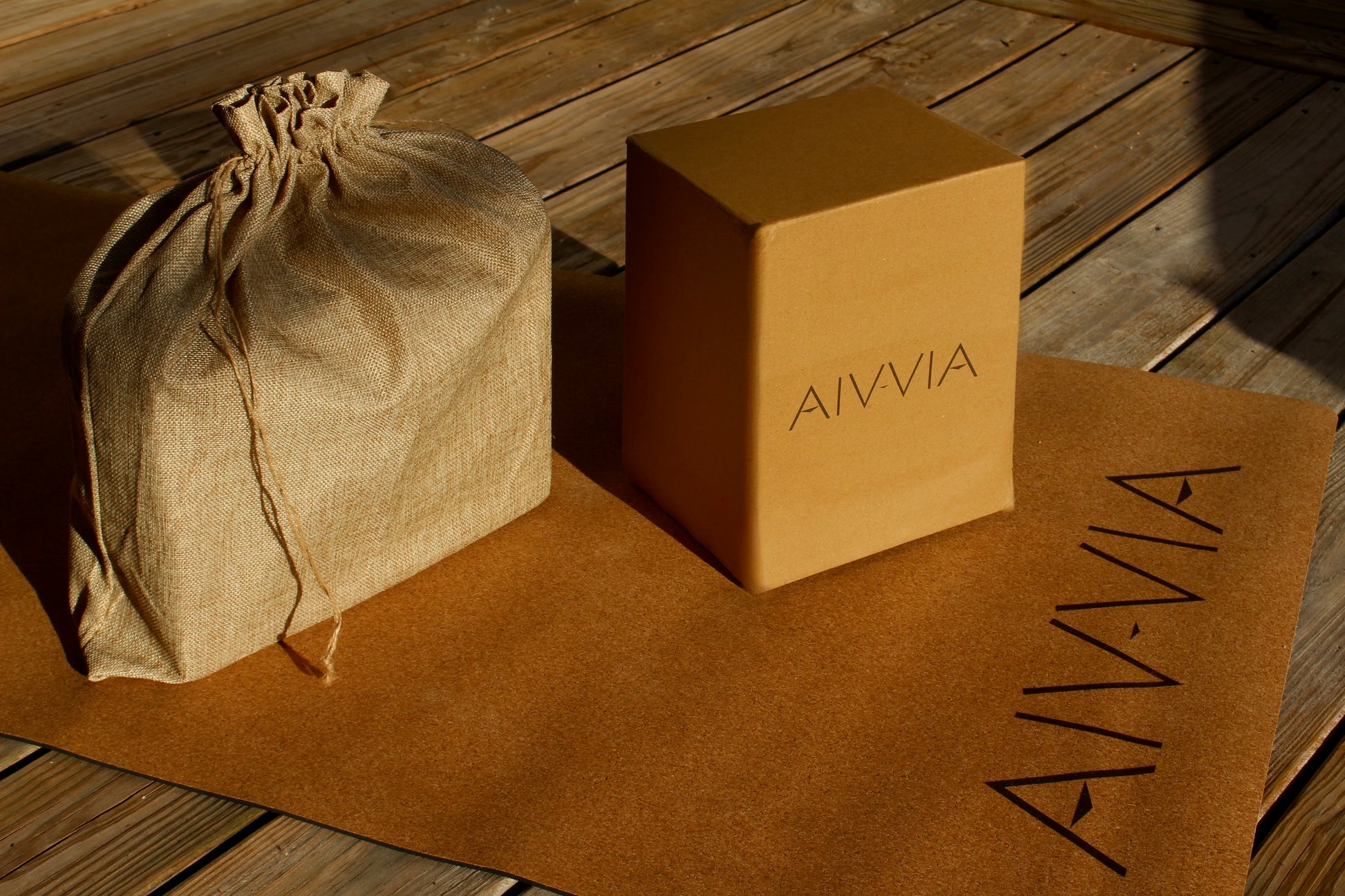 Cork yoga blocks and a drawstring bag displayed on a cork yoga mat.