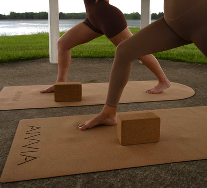 Close-up of a yoga pose using cork yoga blocks under the hands for balance.