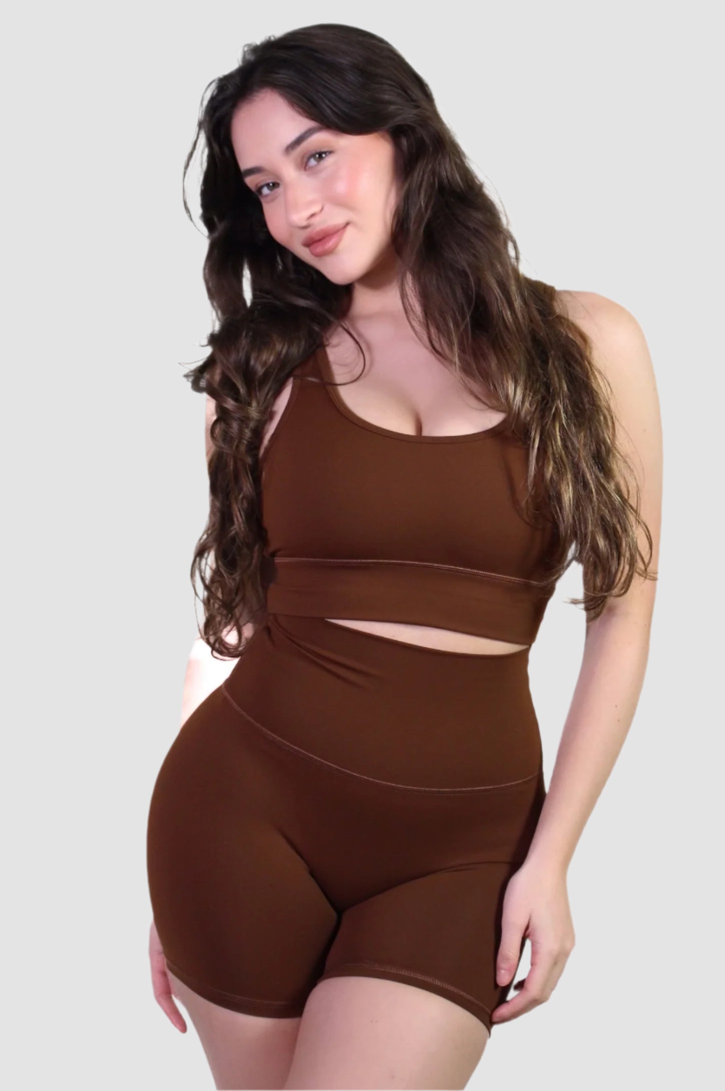 Full front view of the chocolate brown activewear set, featuring a scoop-neck sports bra and high-waisted biker shorts.