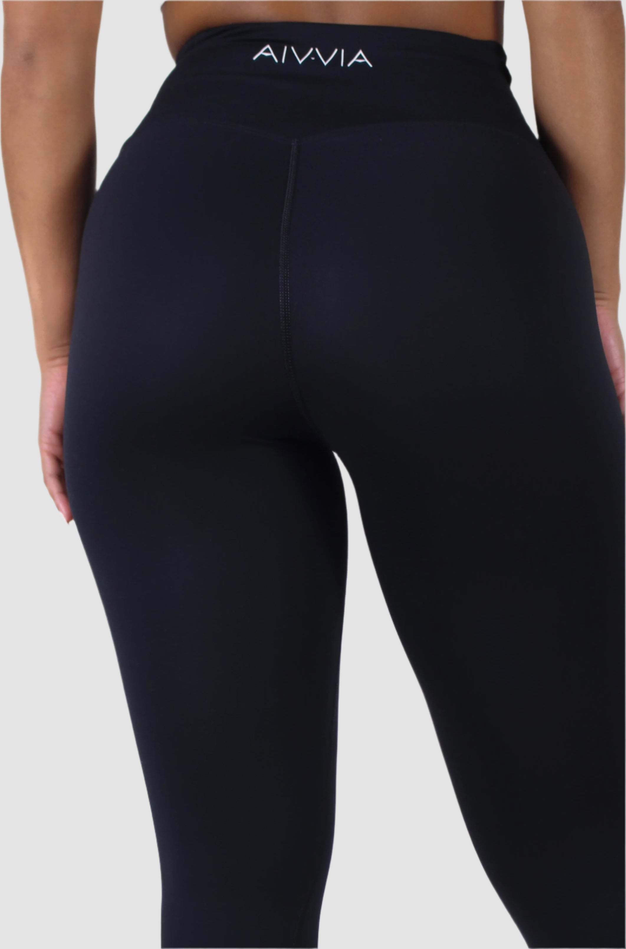 Back waist view of black Aivvia Athletics leggings, women’s workout tights with sleek contour fit.