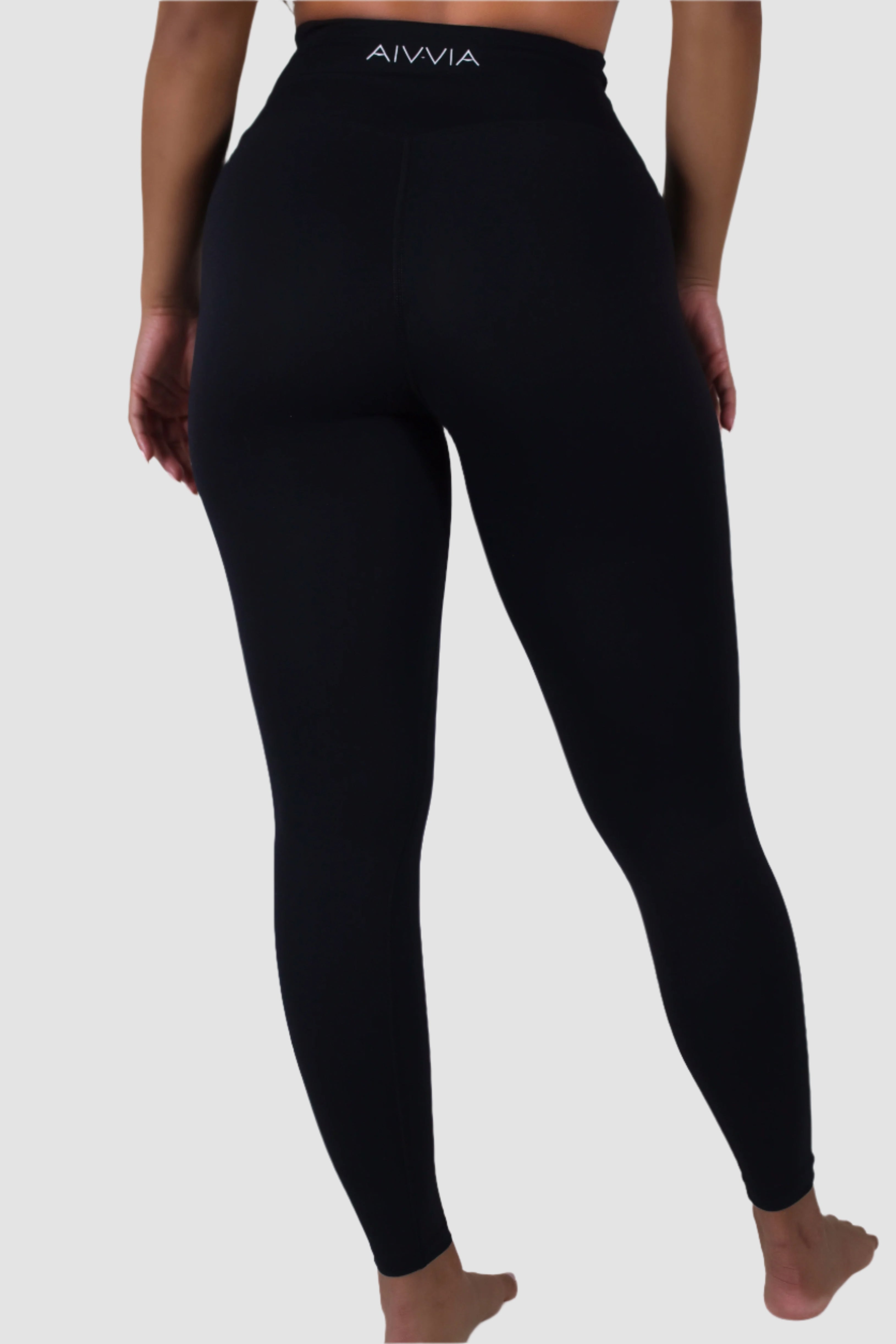Full back view of black Aivvia Athletics leggings, seamless women’s athletic tights for performance wear.