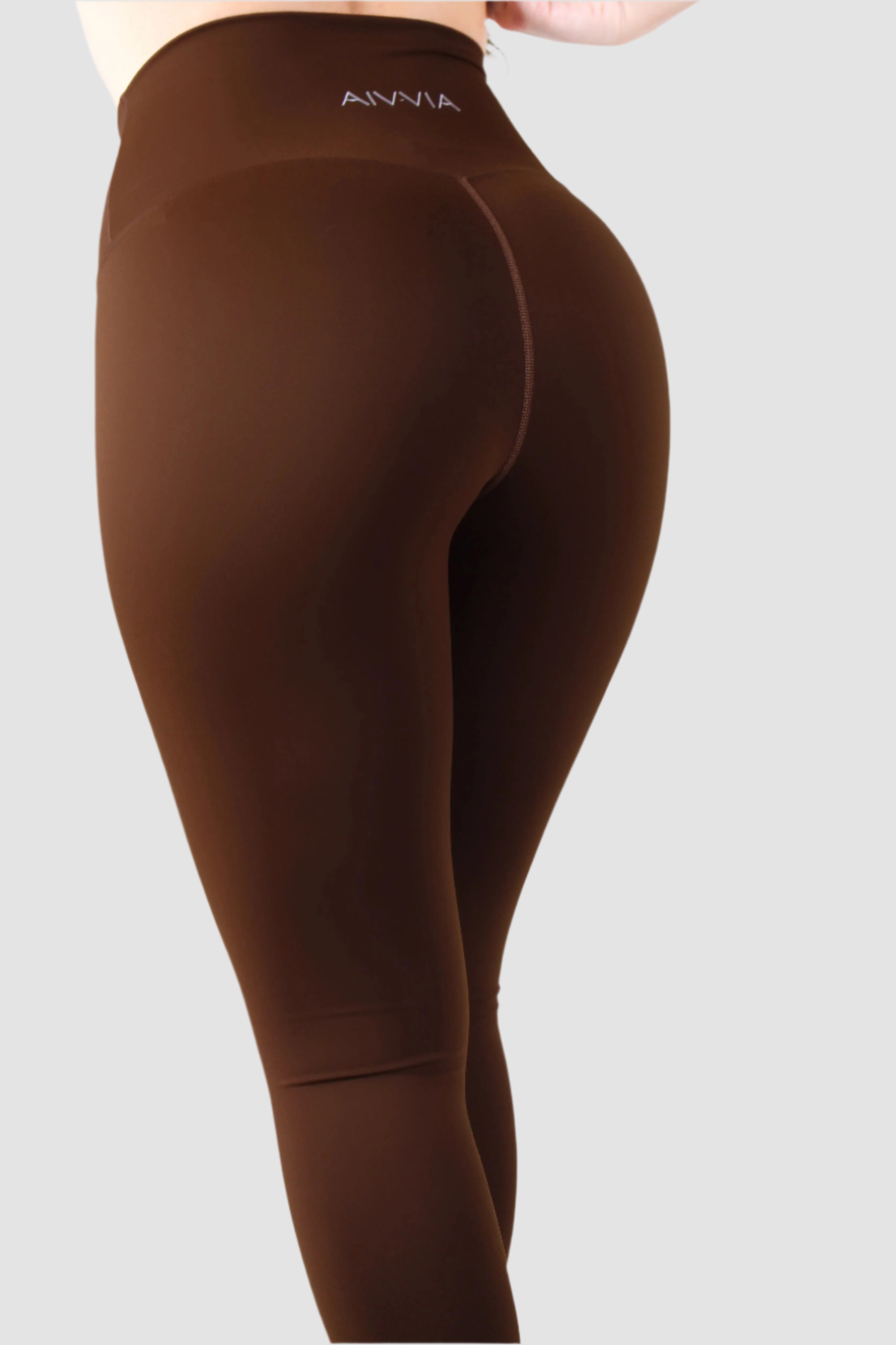 Side view of brown Aivvia Athletics leggings, seamless women’s workout tights with contour fit.