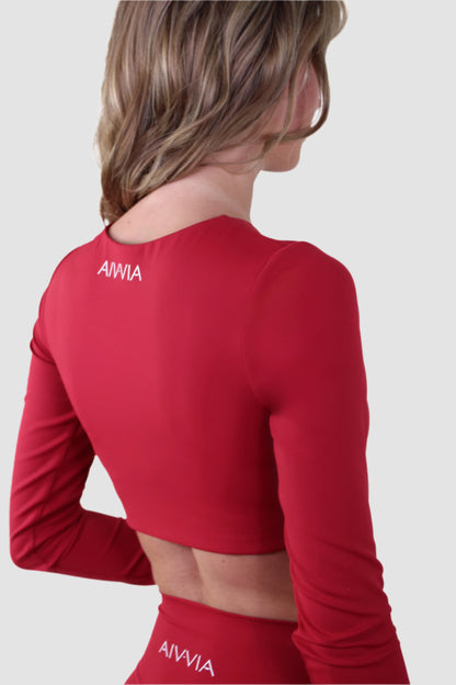 Back view of Aivvia Athletics red long sleeve sports bra featuring breathable performance fabric and secure elastic hem.