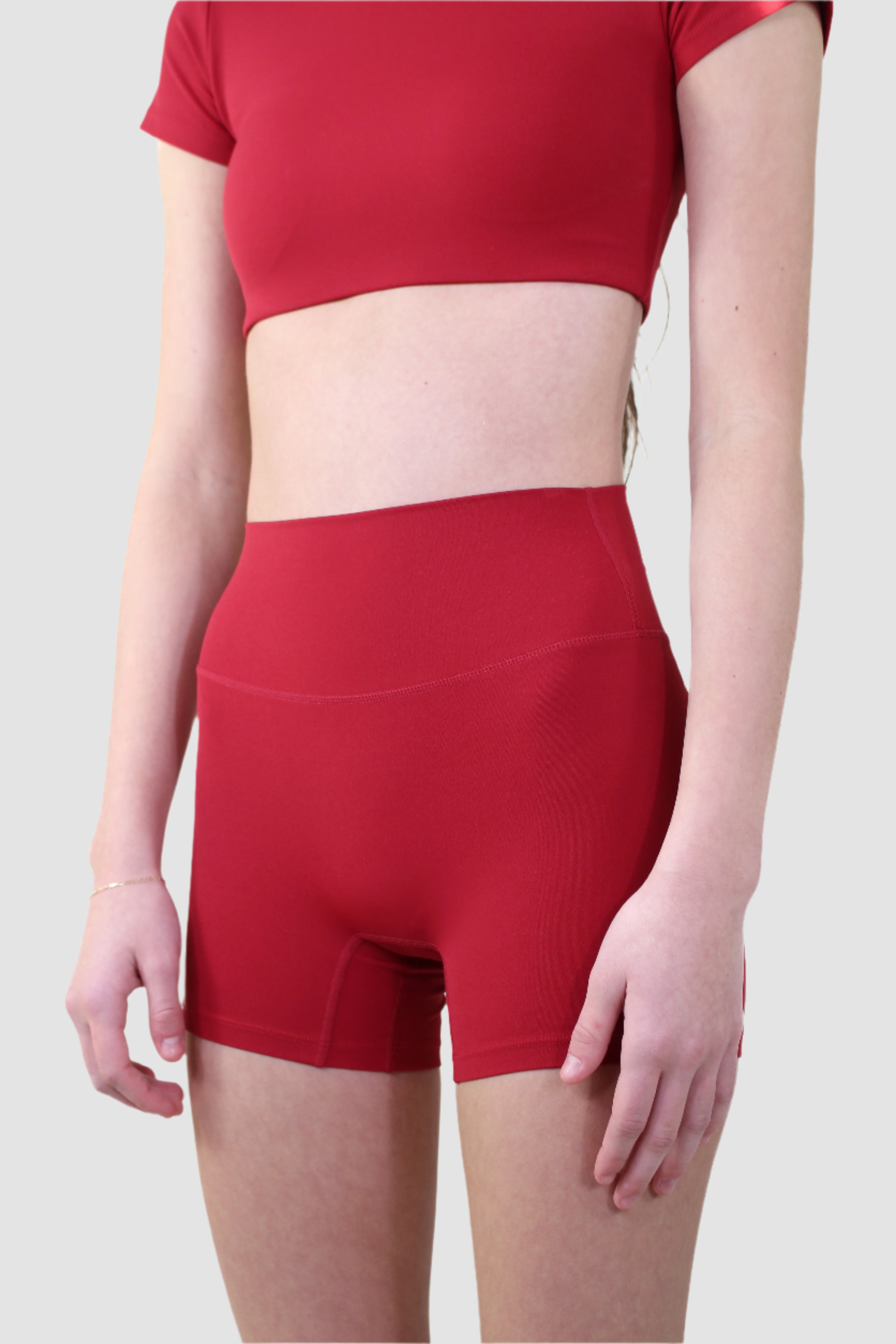 Front view of red Aivvia Athletics workout shorts with high-rise waistband for core support.