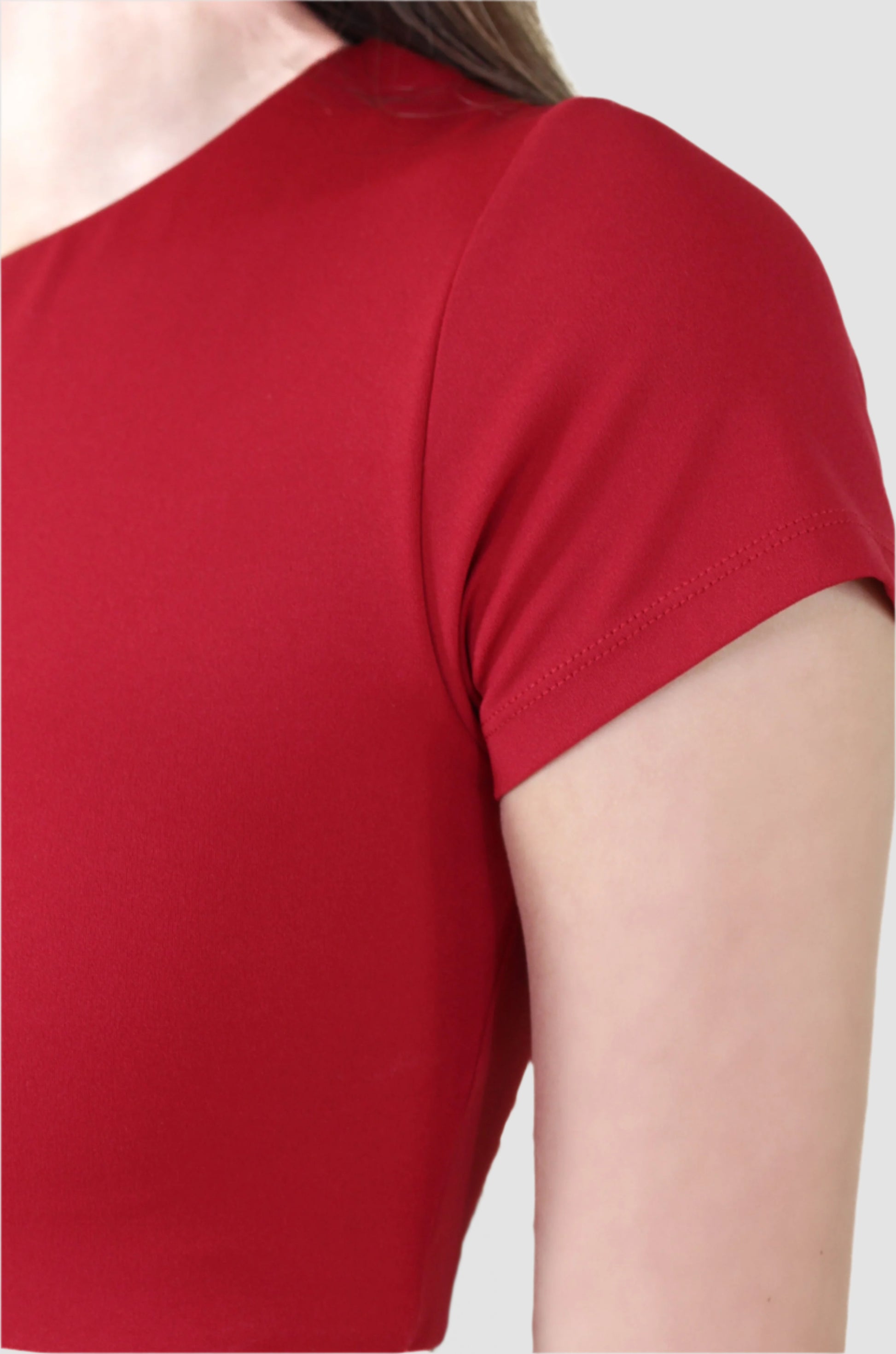 Close-up of red Aivvia athletic crop top sleeve, showcasing stretch fabric and clean seams.