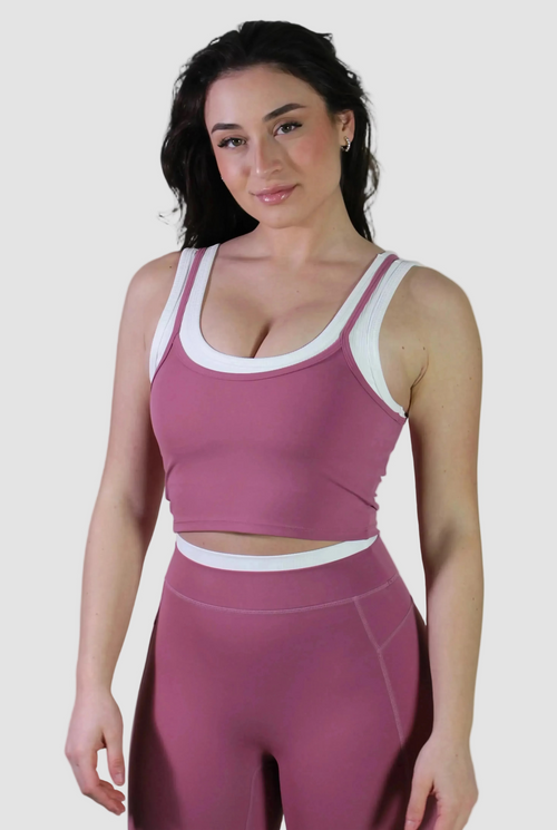 Woman wearing Aivvia Athletics rose pink cropped workout tank and high-waisted leggings gym outfit, stylish women's activewear set for fitness training and workouts.