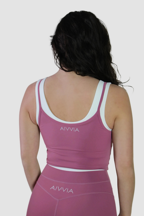 Back view of Aivvia Athletics women's rose pink activewear gym outfit featuring cropped workout tank and high-waisted leggings for training, yoga, and fitness.