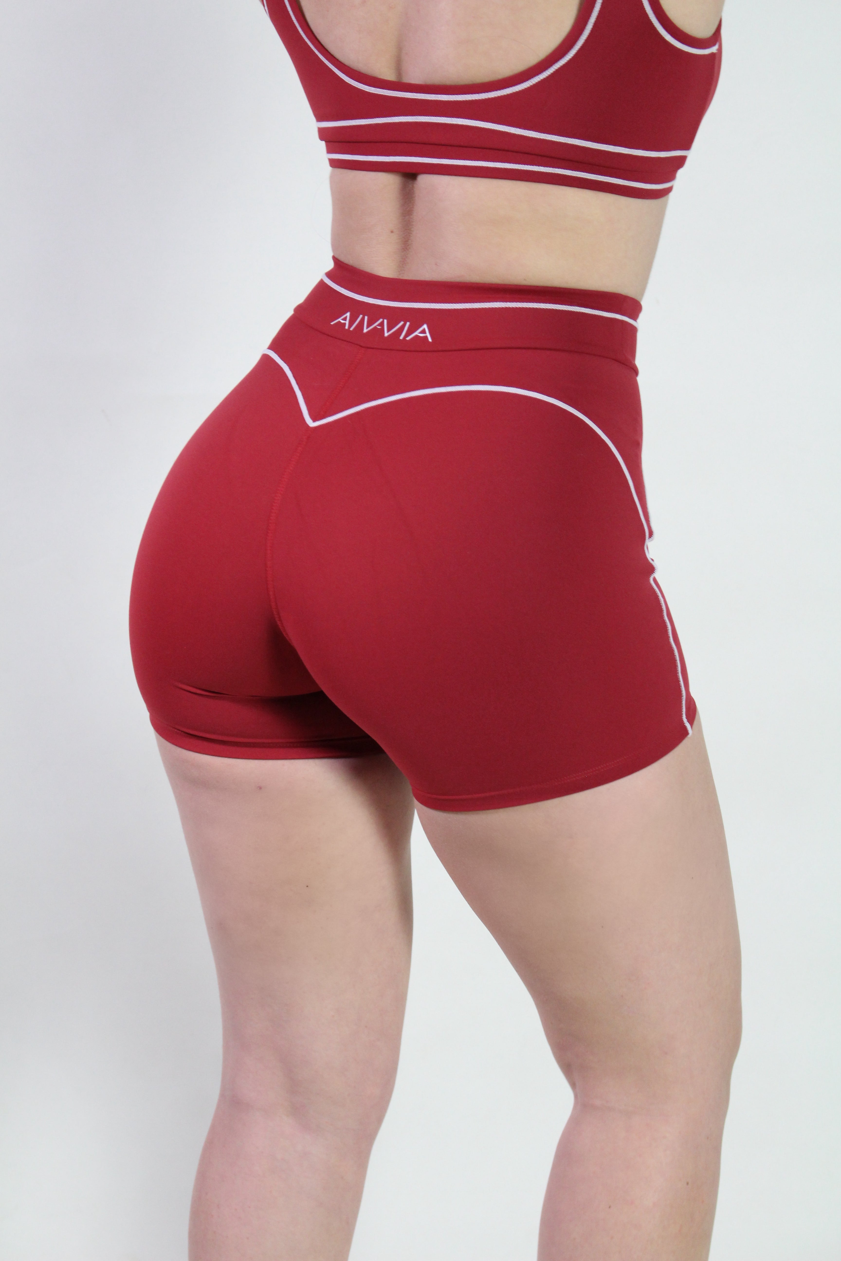 Side back detail of cherry red sculpt shorts highlighting compression fit and flexible waistband, ideal for gym, pilates, and active sports.