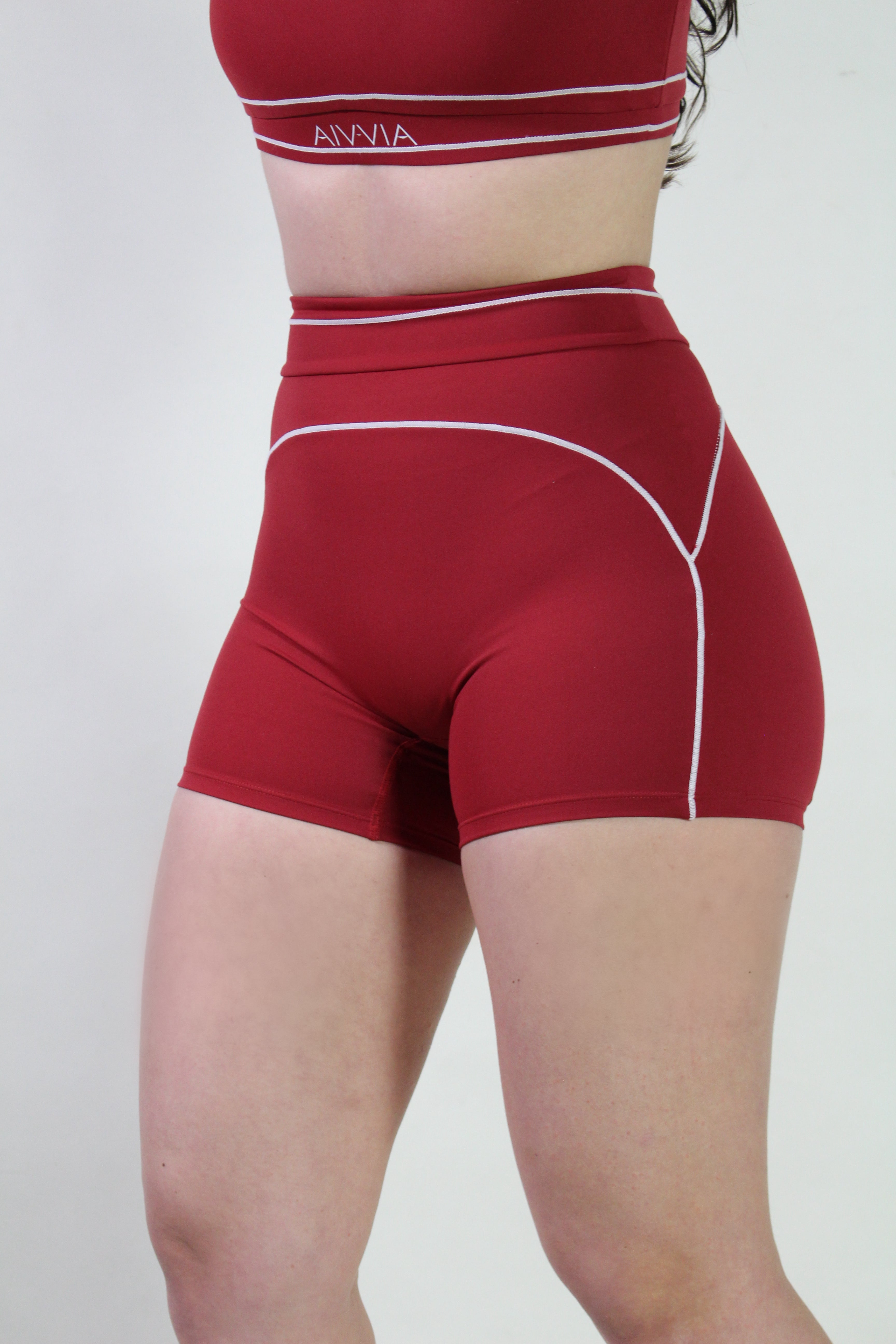 Front view of a woman wearing Cherry Red Sculpt high-waisted shorts with matching scoop neck sports bra, ideal for gym, pilates, and active workouts.
