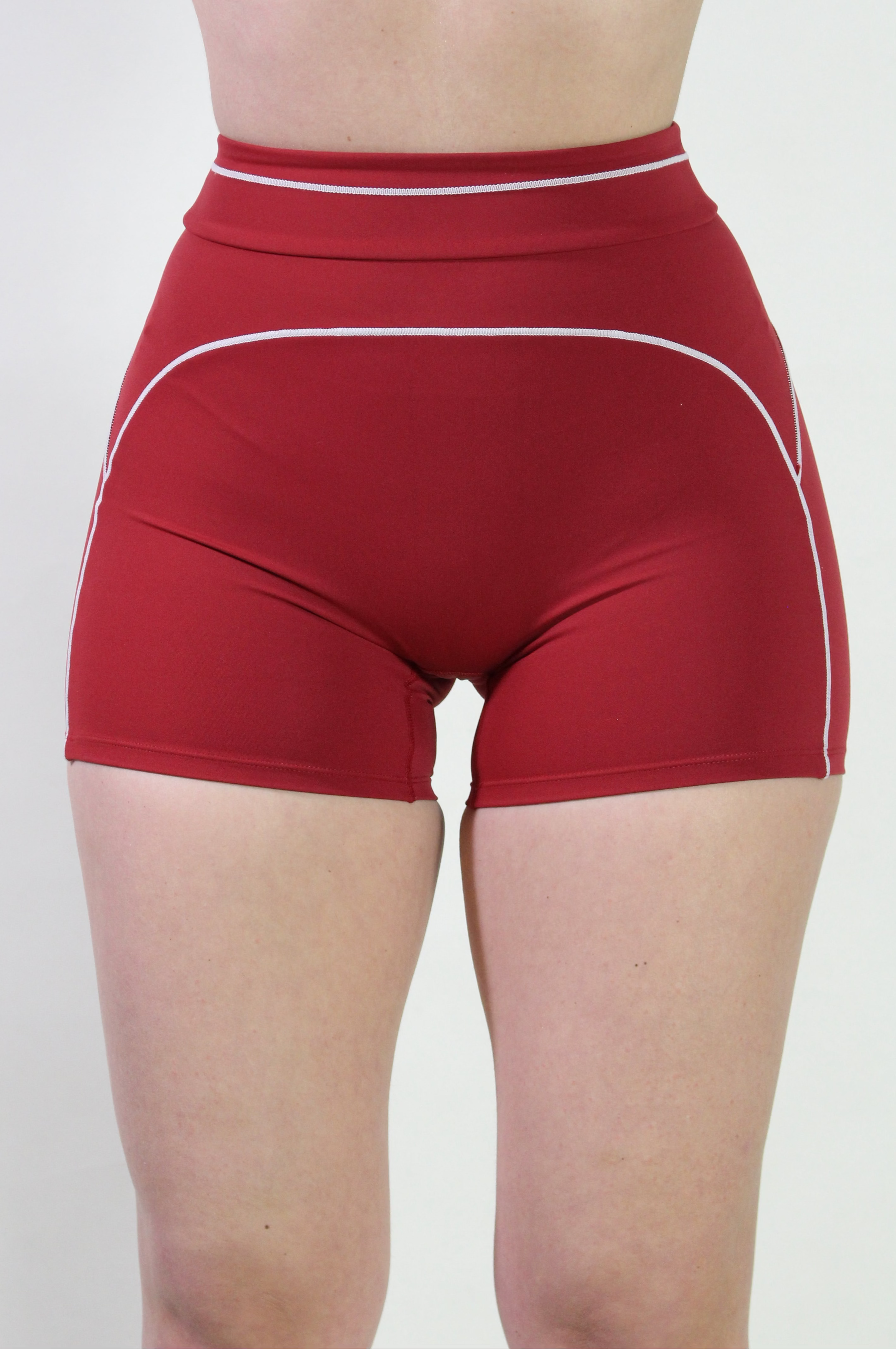 Front view of a woman wearing Cherry Red Sculpt high-waisted shorts with matching scoop neck sports bra, ideal for gym, pilates, and active workouts.