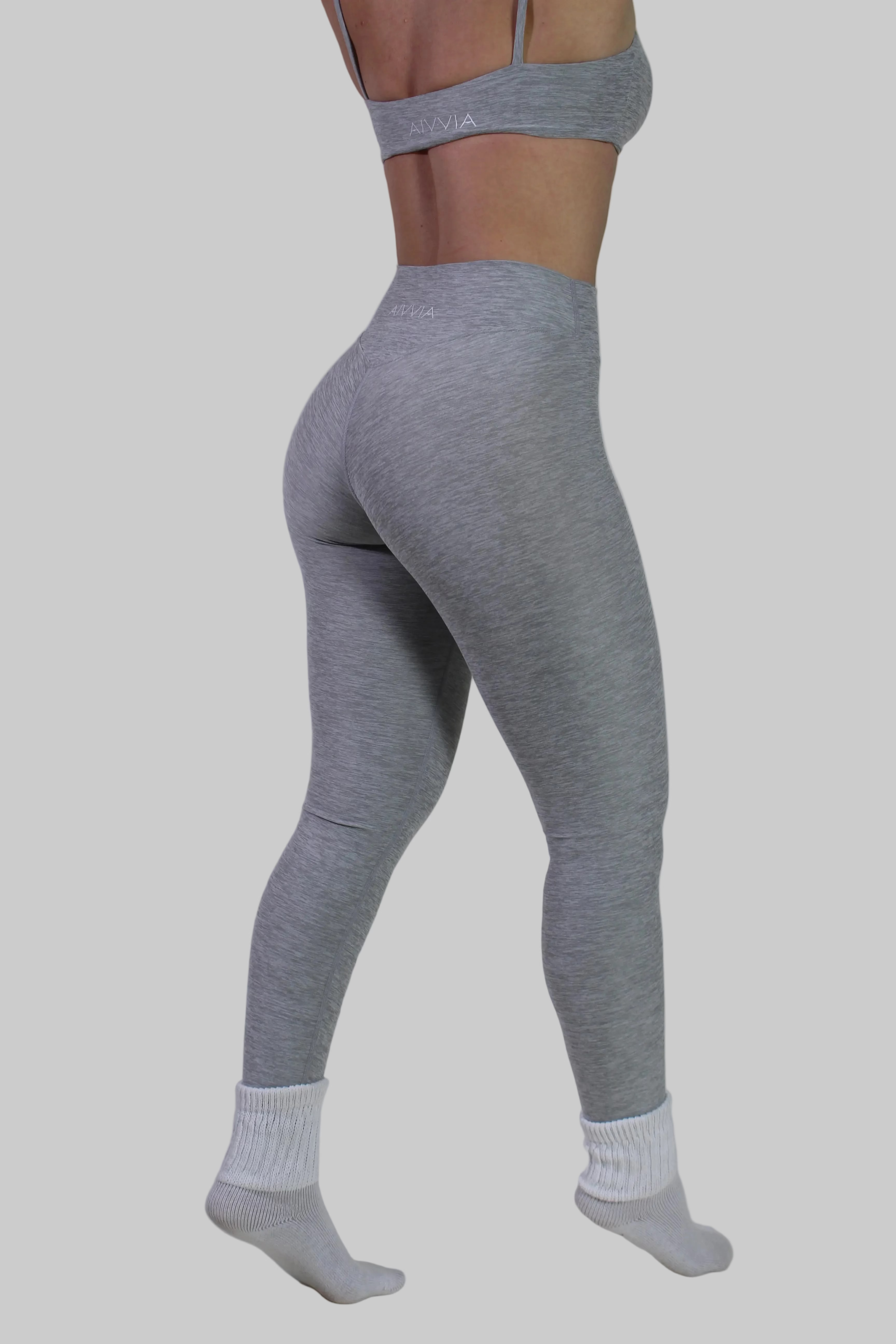 Close-up of Aivvia Athletics leggings back, focusing on glute-contouring seams and logo on center-back waistband.