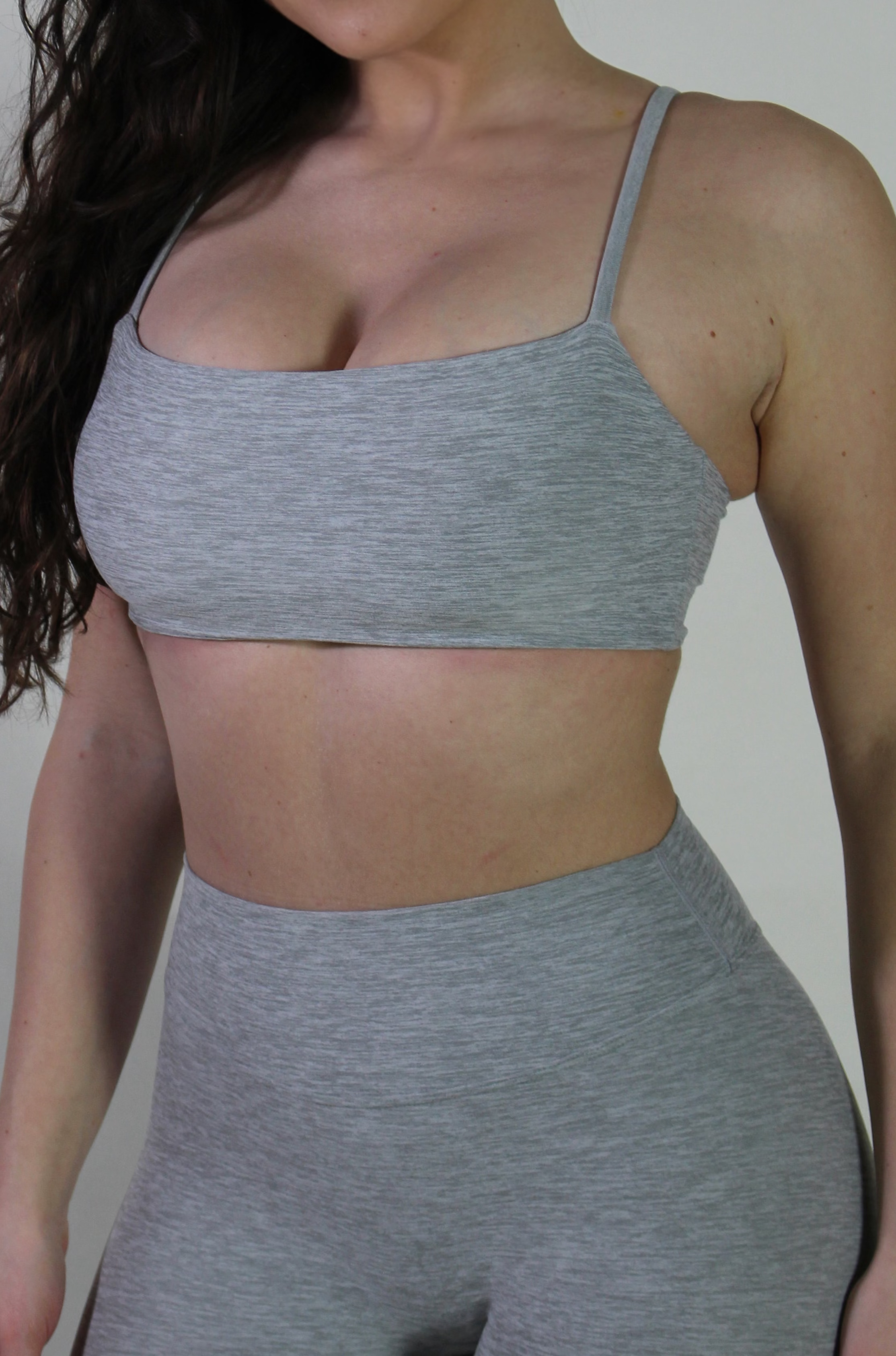 Angled front view of Aivvia Athletics gray marl tube top bra, highlighting longline minimal silhouette for activewear.