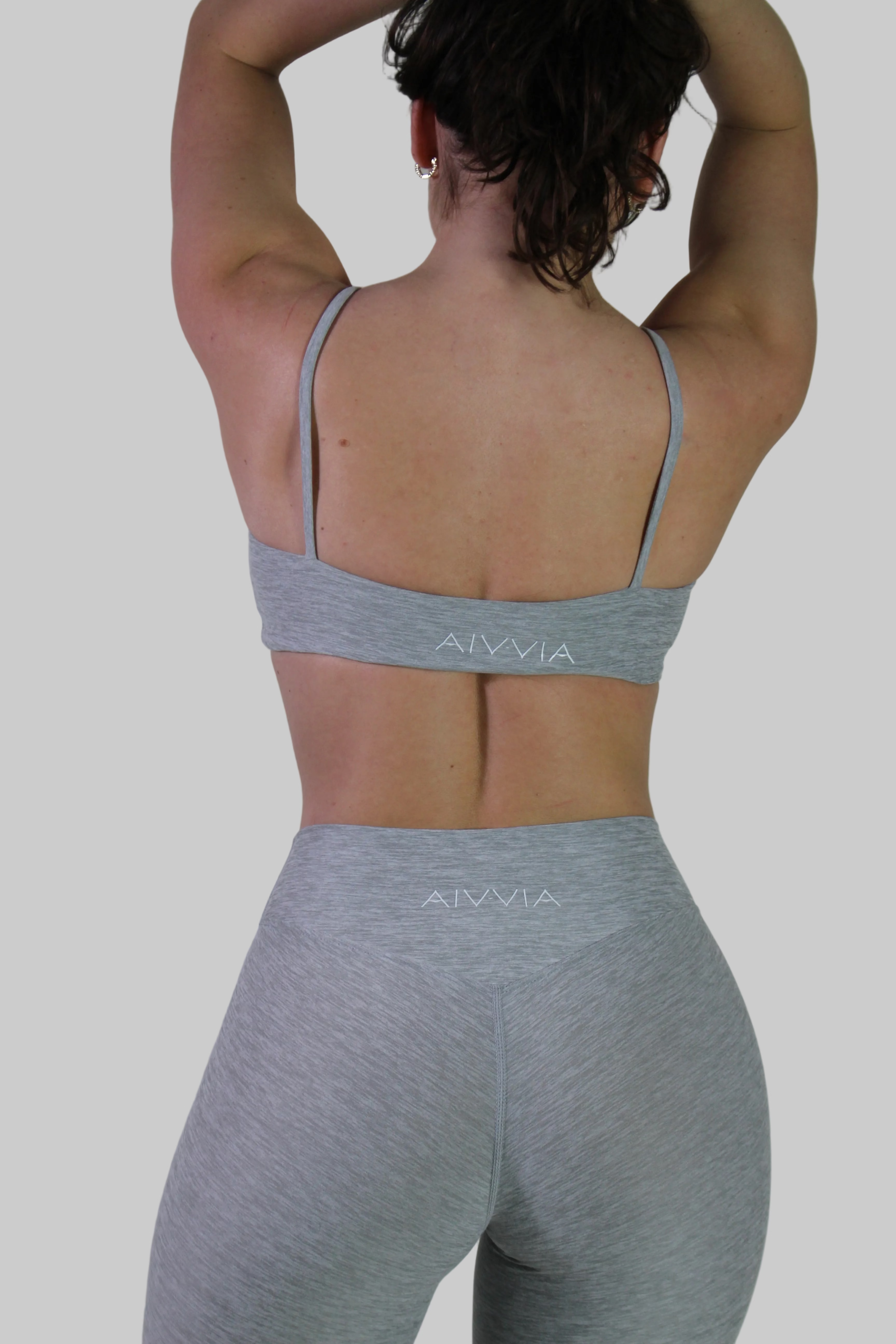 Rear view of Aivvia Athletics gray marl tube top bra, showing horizontal backline and logo on underband.