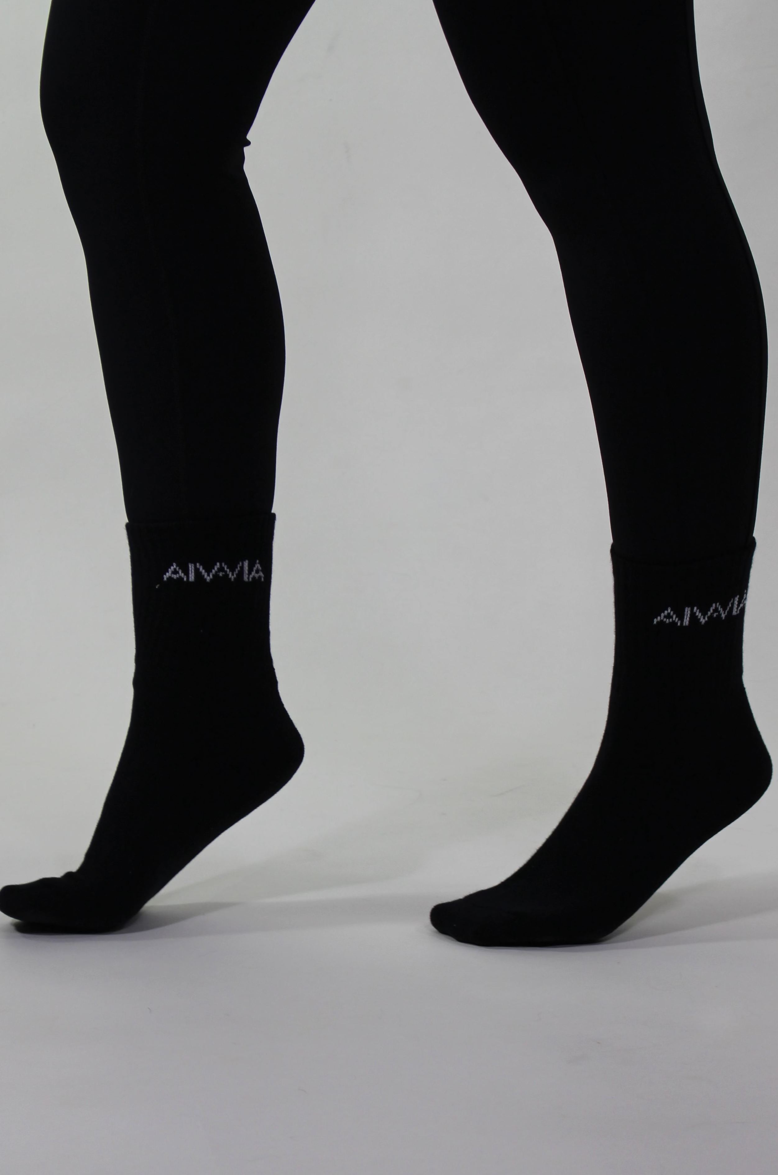 Black socks with a brand logo on a gray background