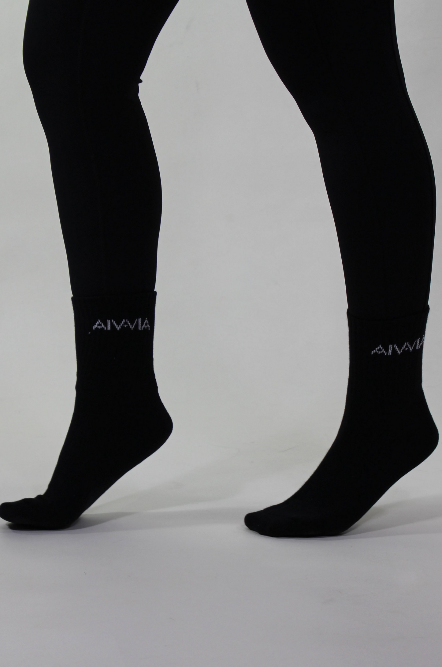 Black socks with a brand logo on a gray background