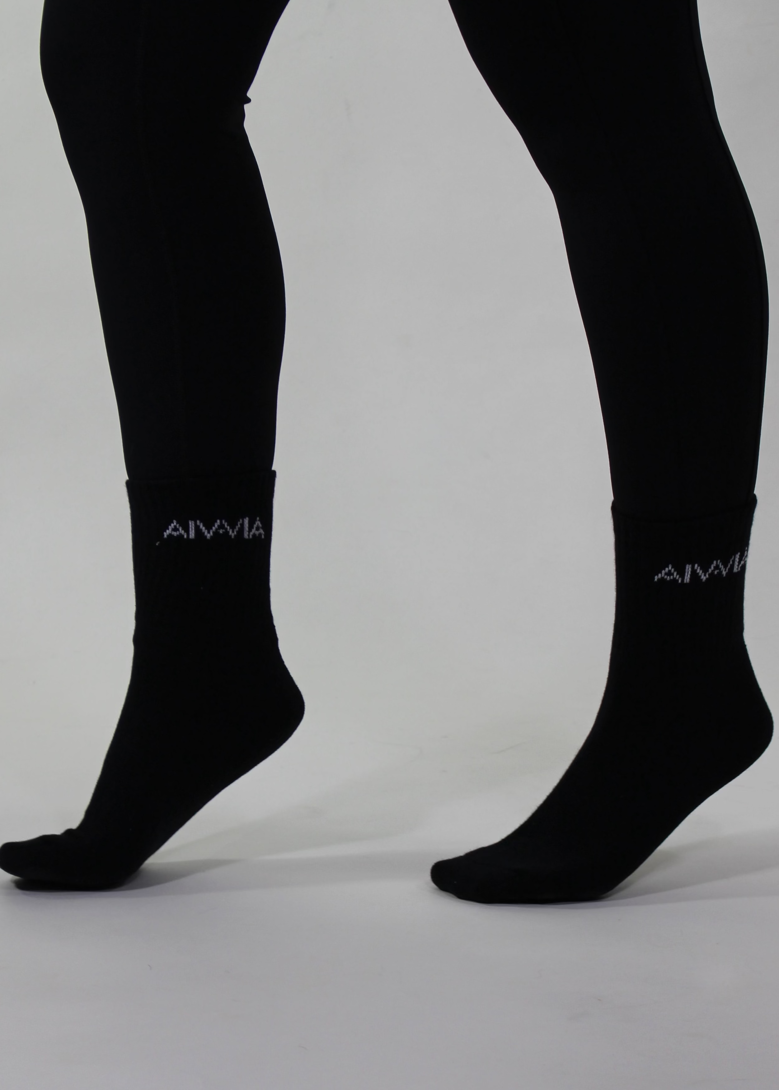 Black socks with a brand logo on a gray background