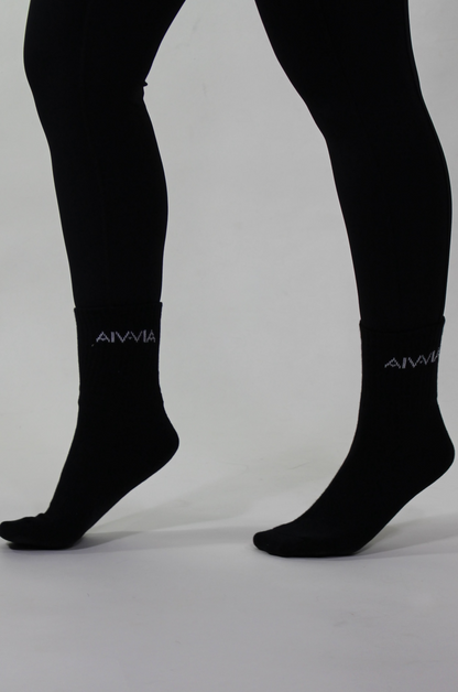 Black socks with a brand logo on a gray background