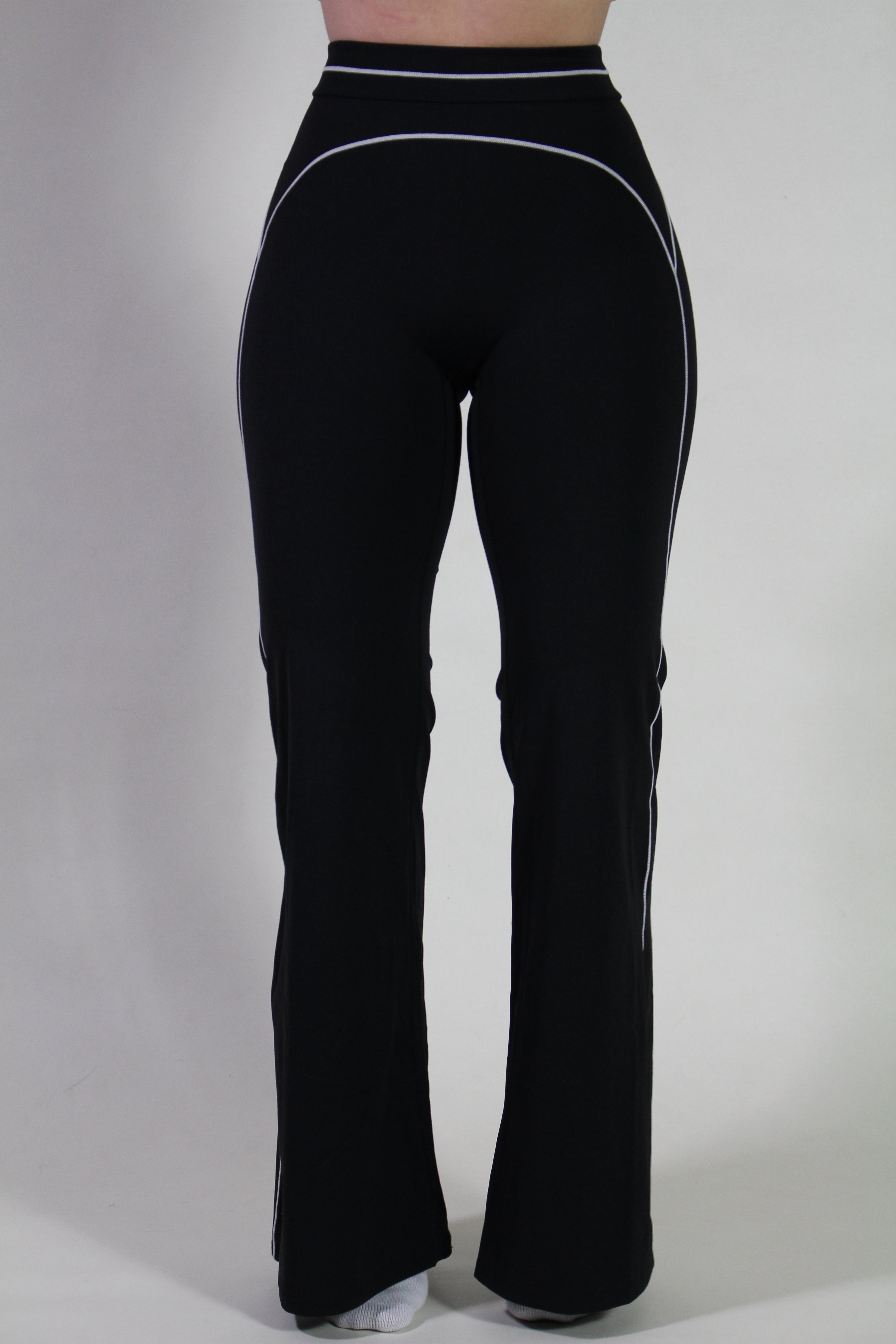 Close-up front view showing smooth sculpting seams and flared leggings from Aivvia Athletics, designed for yoga, pilates, and gym training.